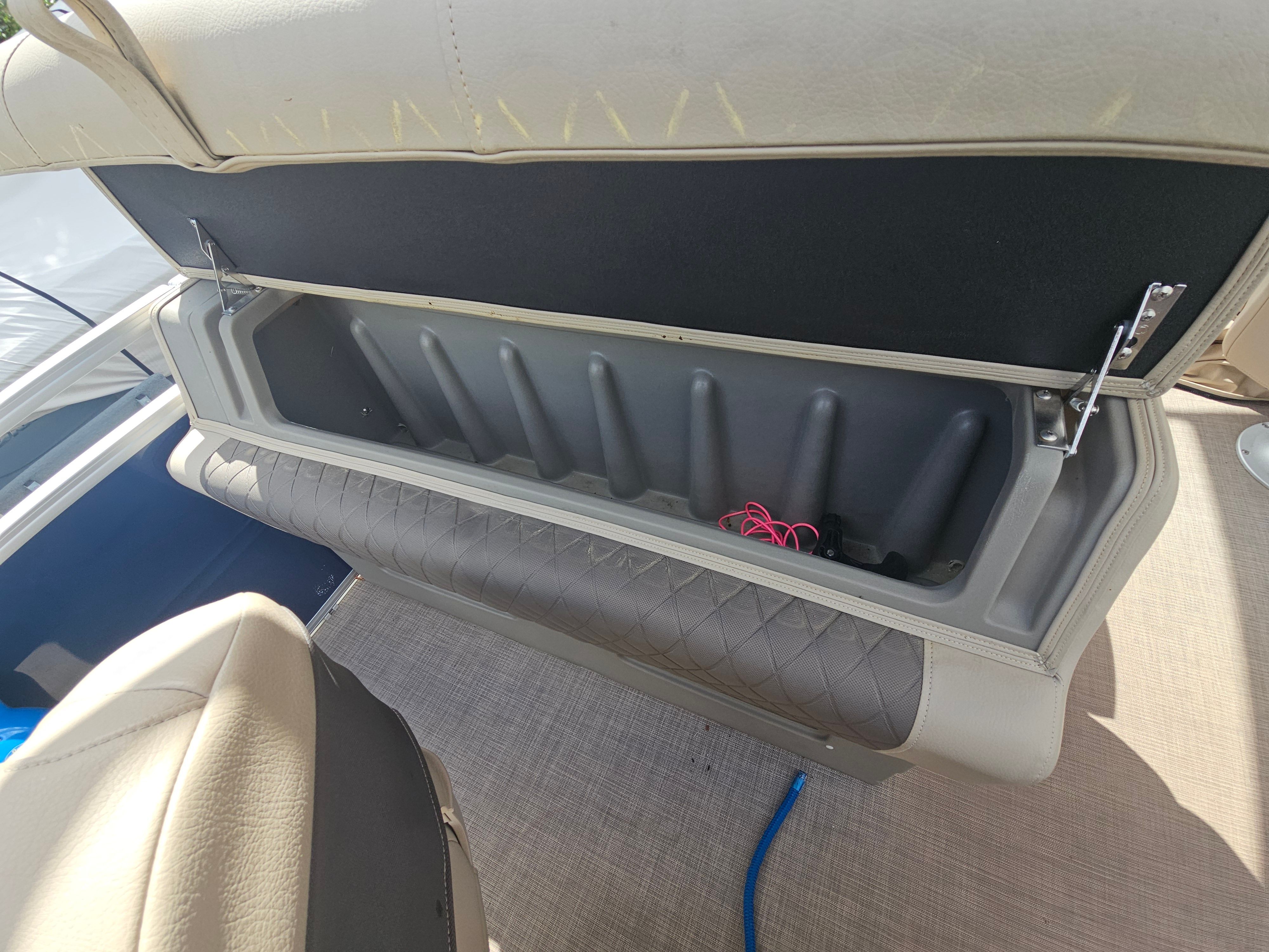2024 Sun Tracker Fishin' Barge 22 DLX seat storage compartment.