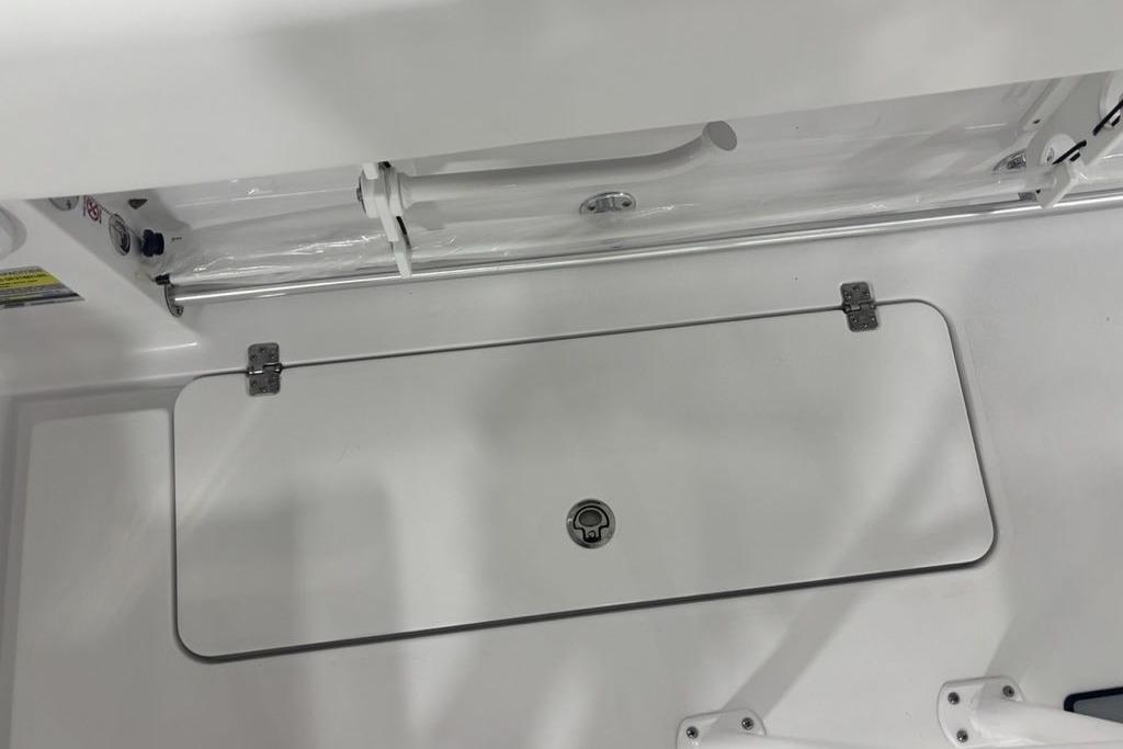 2026 Sportsman Open 252 Center Console boat storage compartment with latch and hinges.