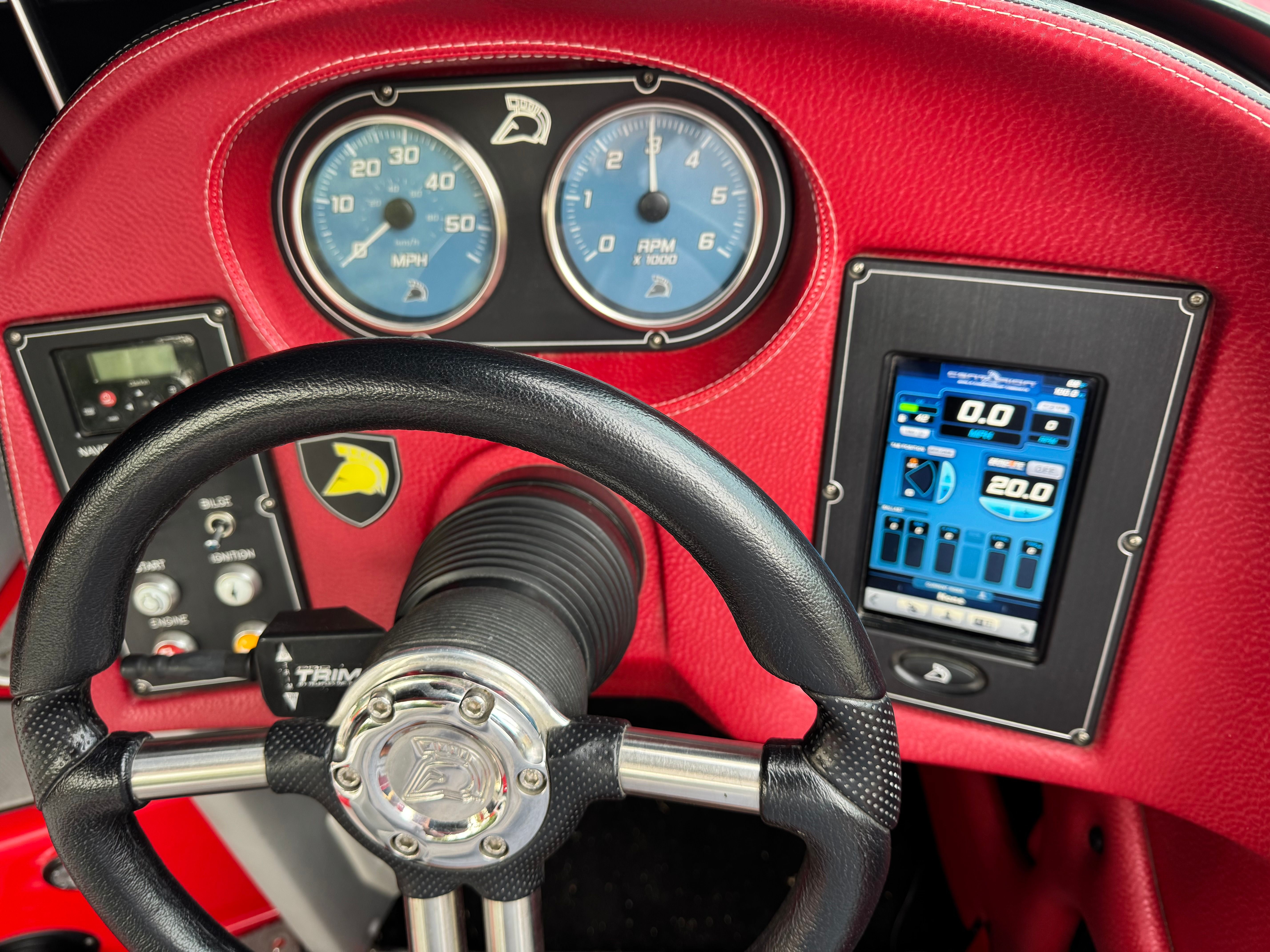 The image shows the dashboard of a 2013 Centurion Enzo SV211 with red accents.