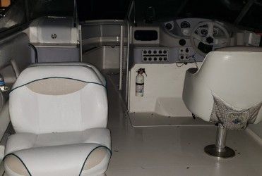 Interior of a 1996 Wellcraft 2400S boat with white seating.