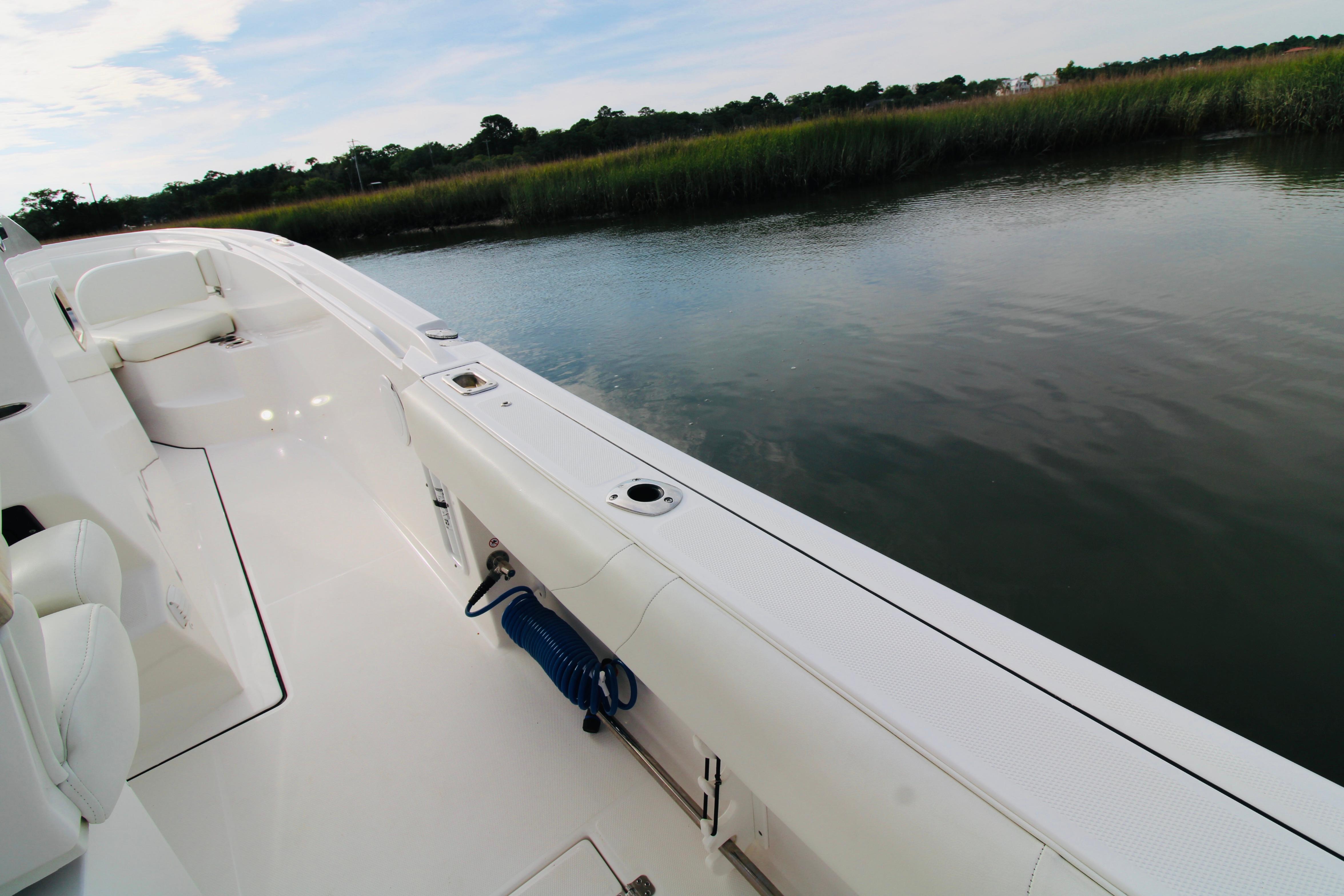 2022 Edgewater 280CC boat interior, featuring sleek white seating and calm waters.