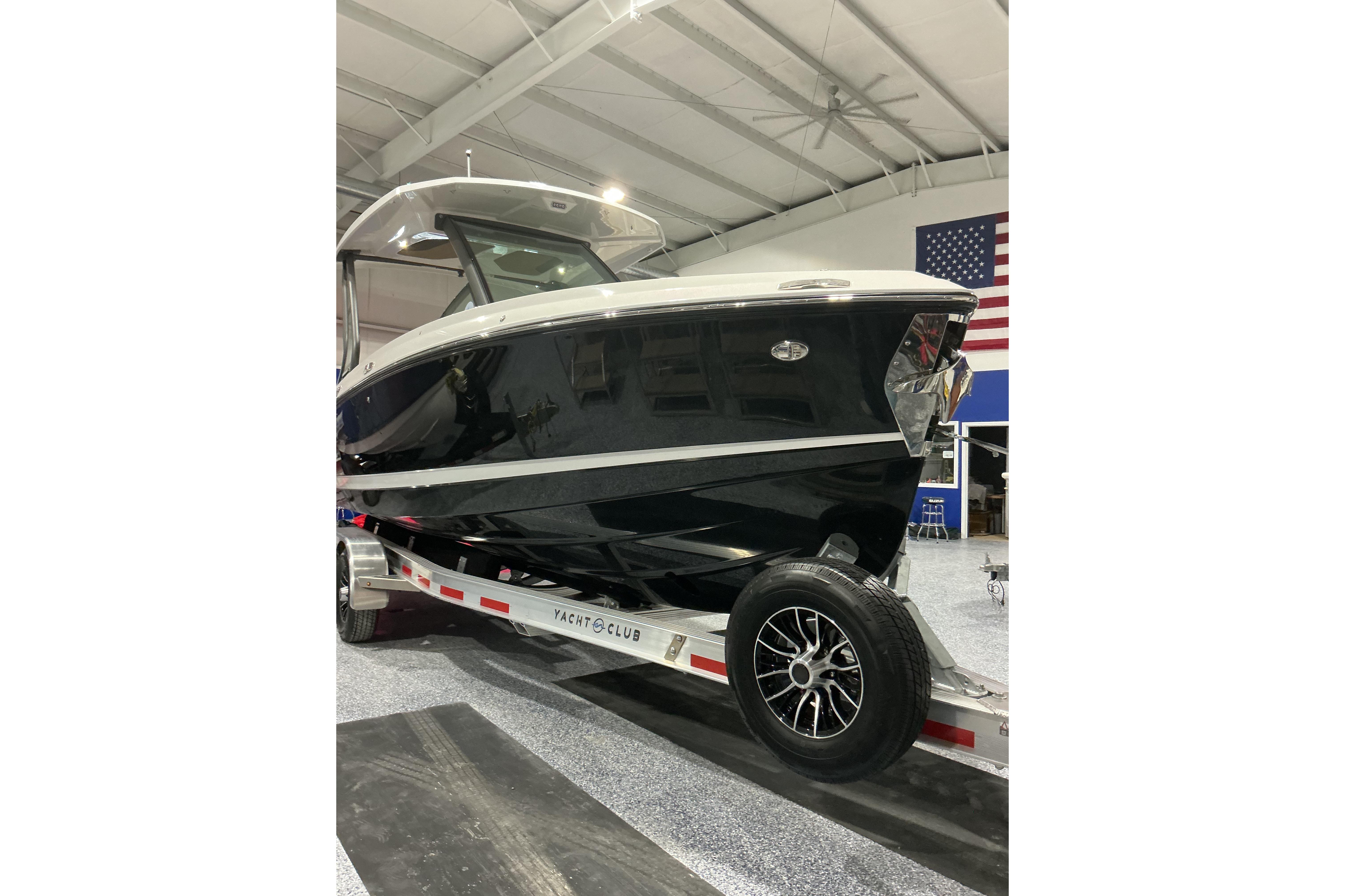 2026 Monterey Elite 25 SD boat on trailer in indoor showroom.