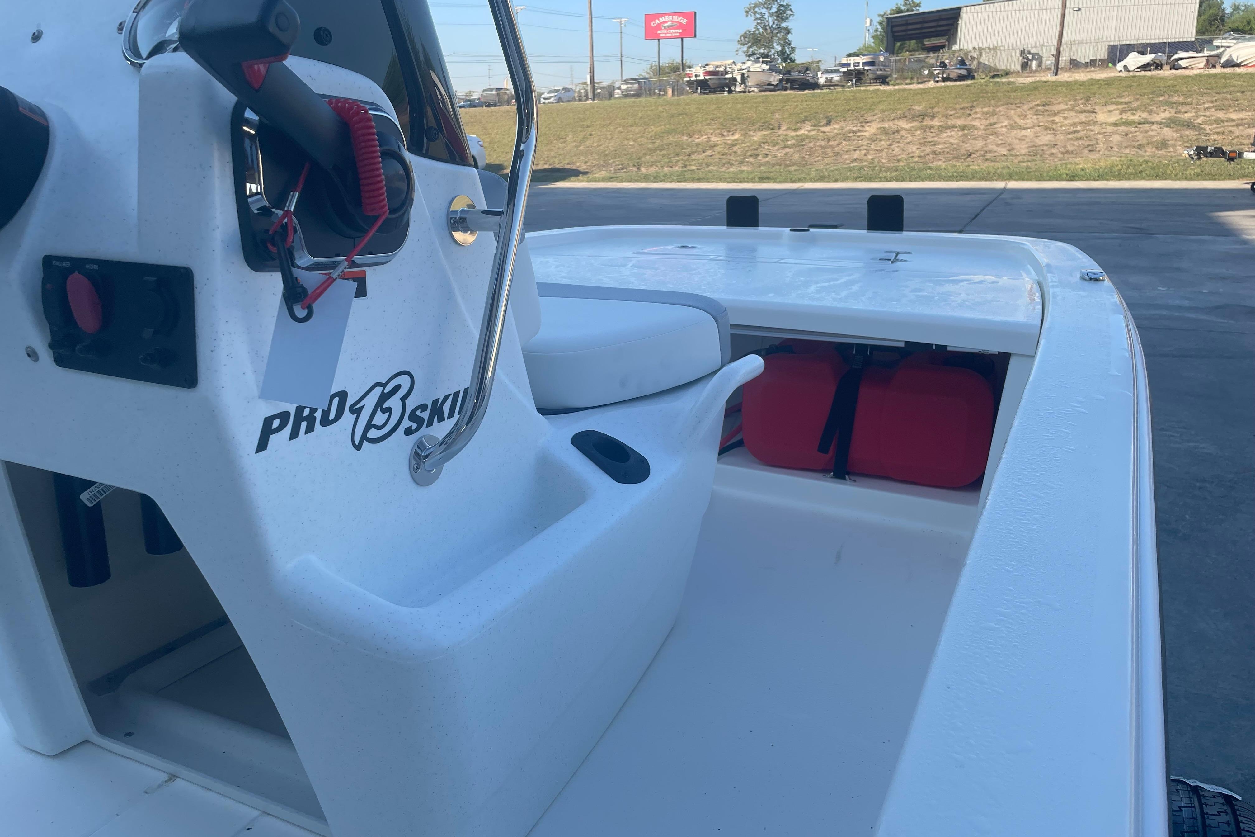 2026 Mako Pro Skiff 13 CC boat interior with steering console and storage area.