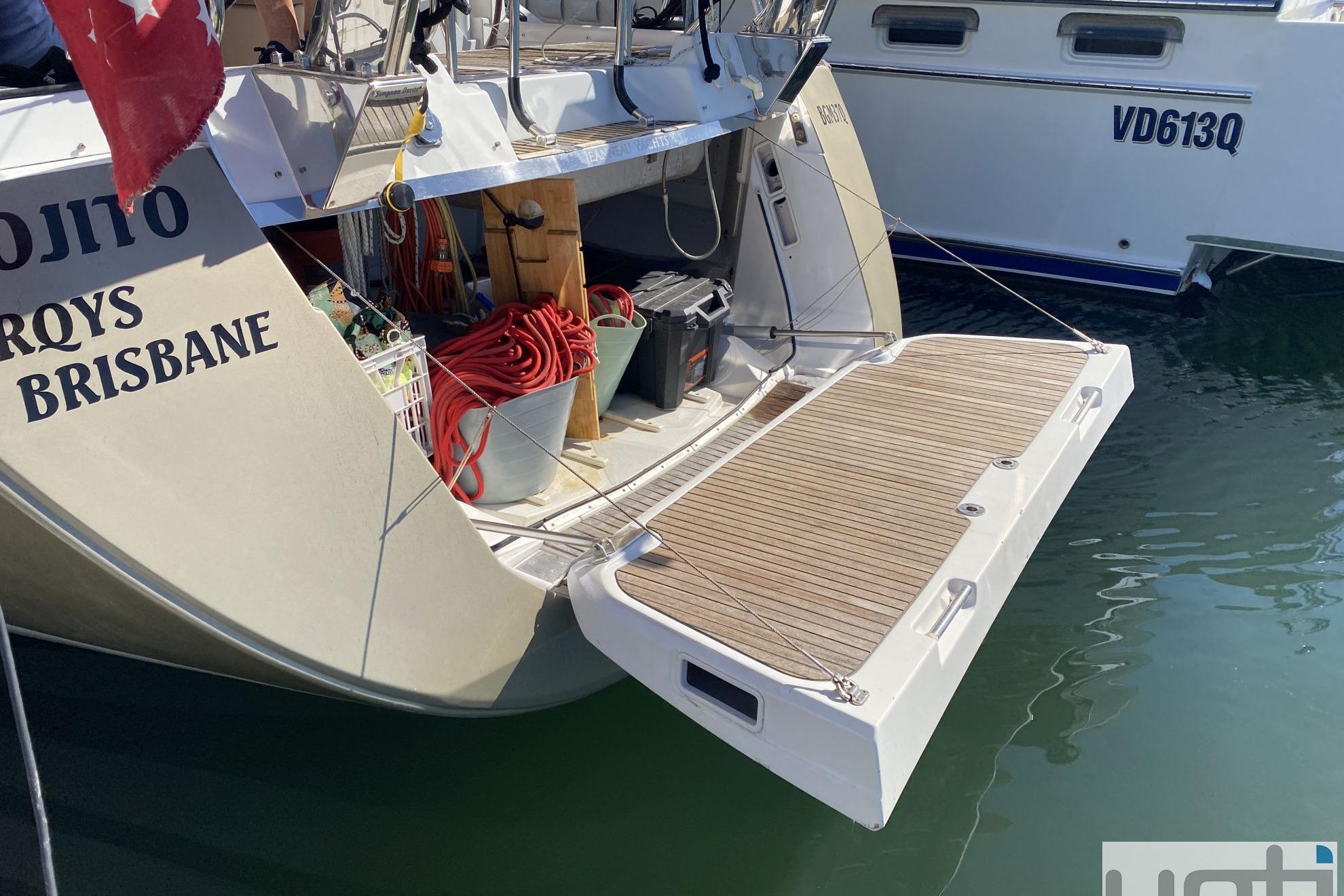 Jeanneau 57 yacht, 2015 model, docked with open swim platform and visible equipment.