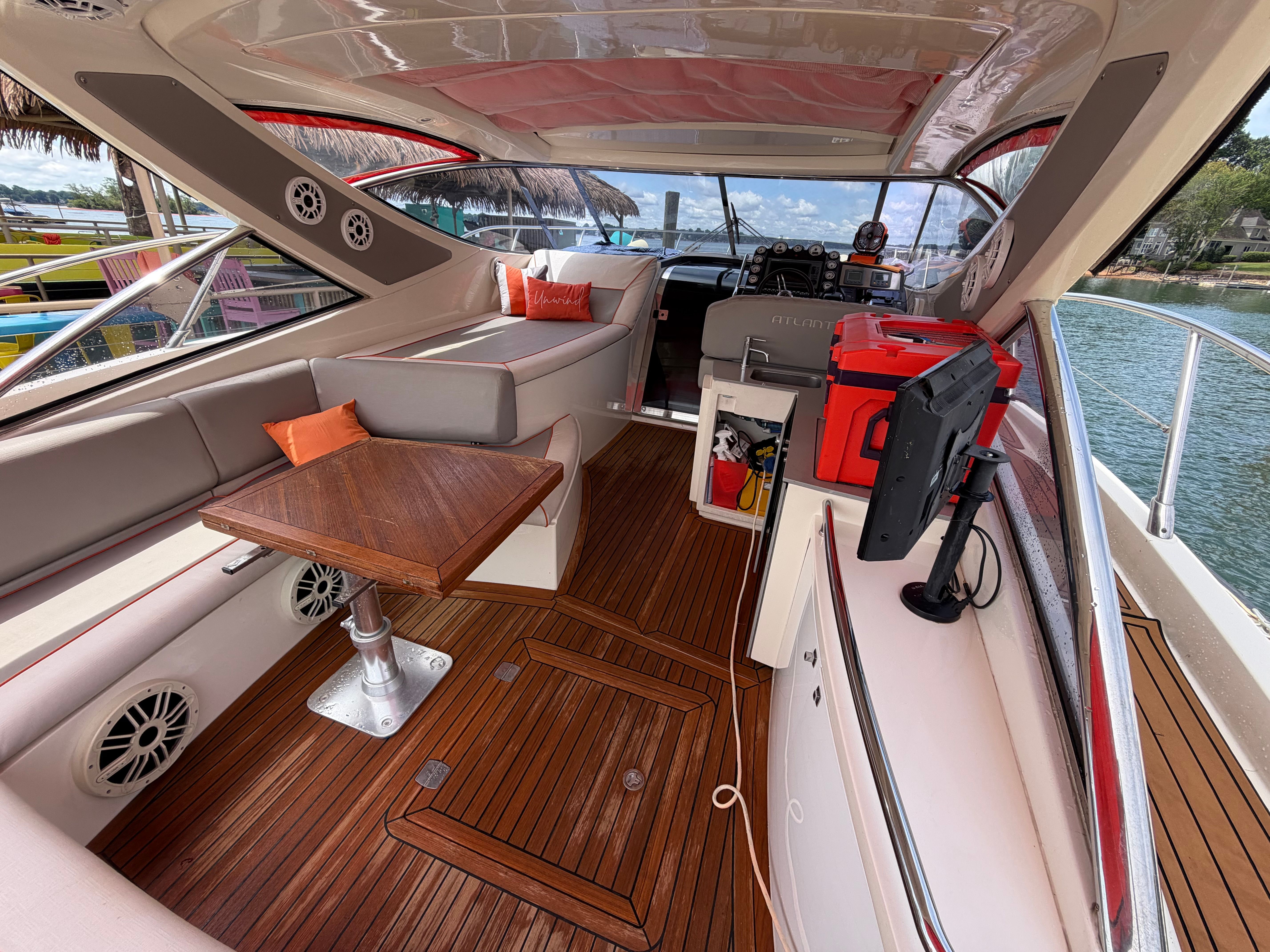 The image shows the cockpit of a 2011 Azimut Atlantis 40 with elegant wood flooring and comfortable seating.