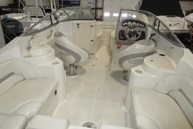 2004 Stingray 240 LR boat interior with seating, steering wheel, and dashboard.