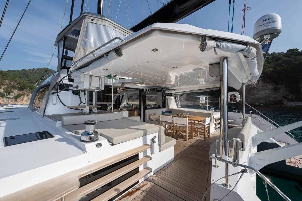 Luxury Privilege Signature 580 yacht deck, 2025 model, featuring elegant seating and dining area.