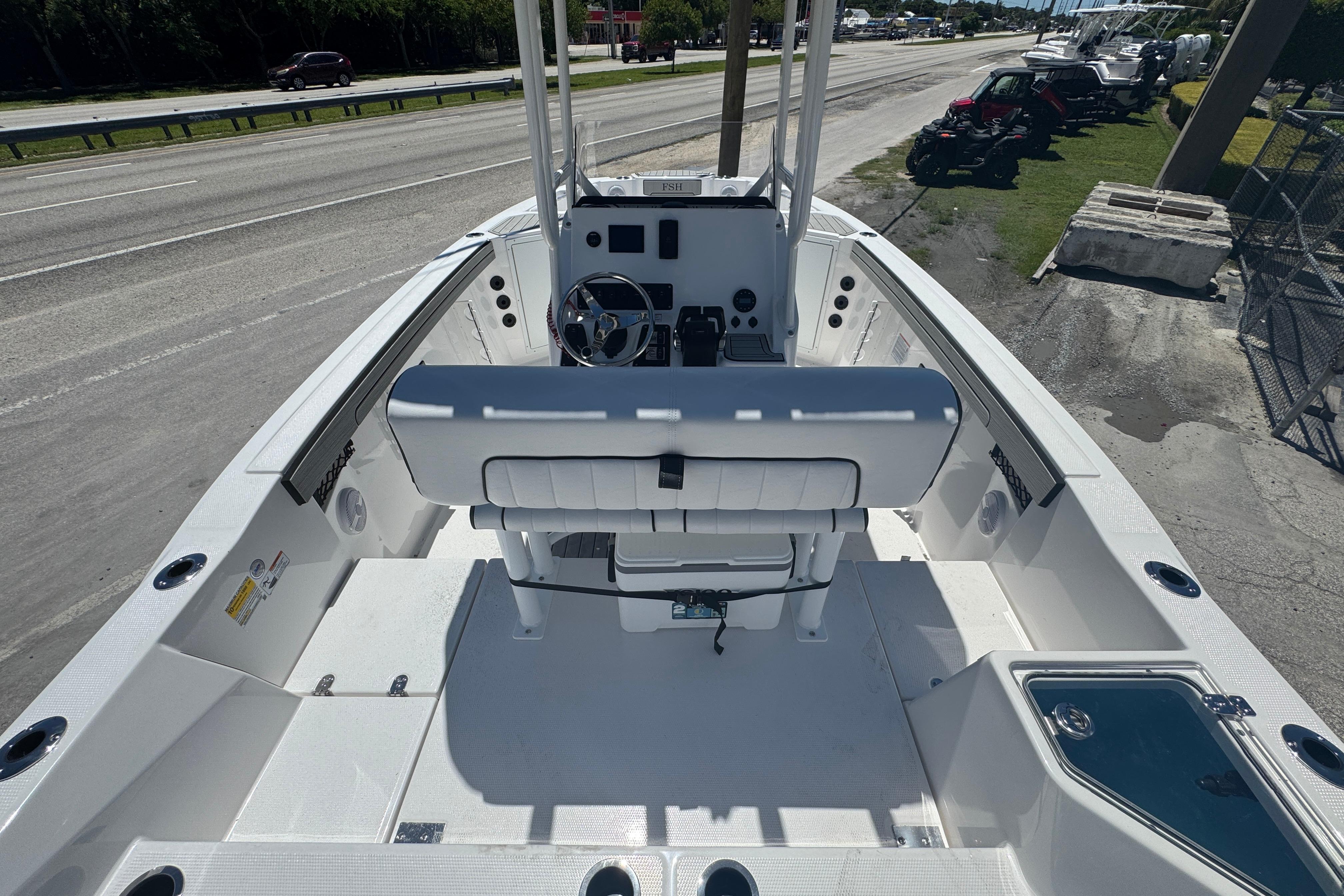2026 Yamaha Boats 220 FSH Sport, sleek white interior, parked on roadside.