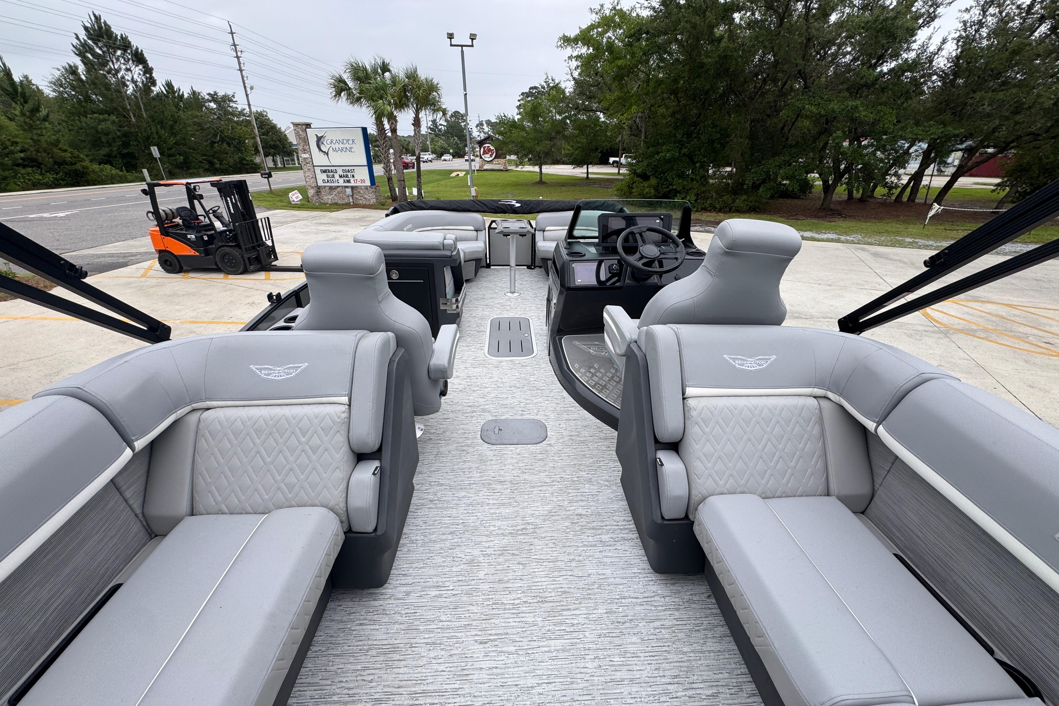 2027 Bennington 24 MFB pontoon boat interior with luxurious gray seating and modern helm.