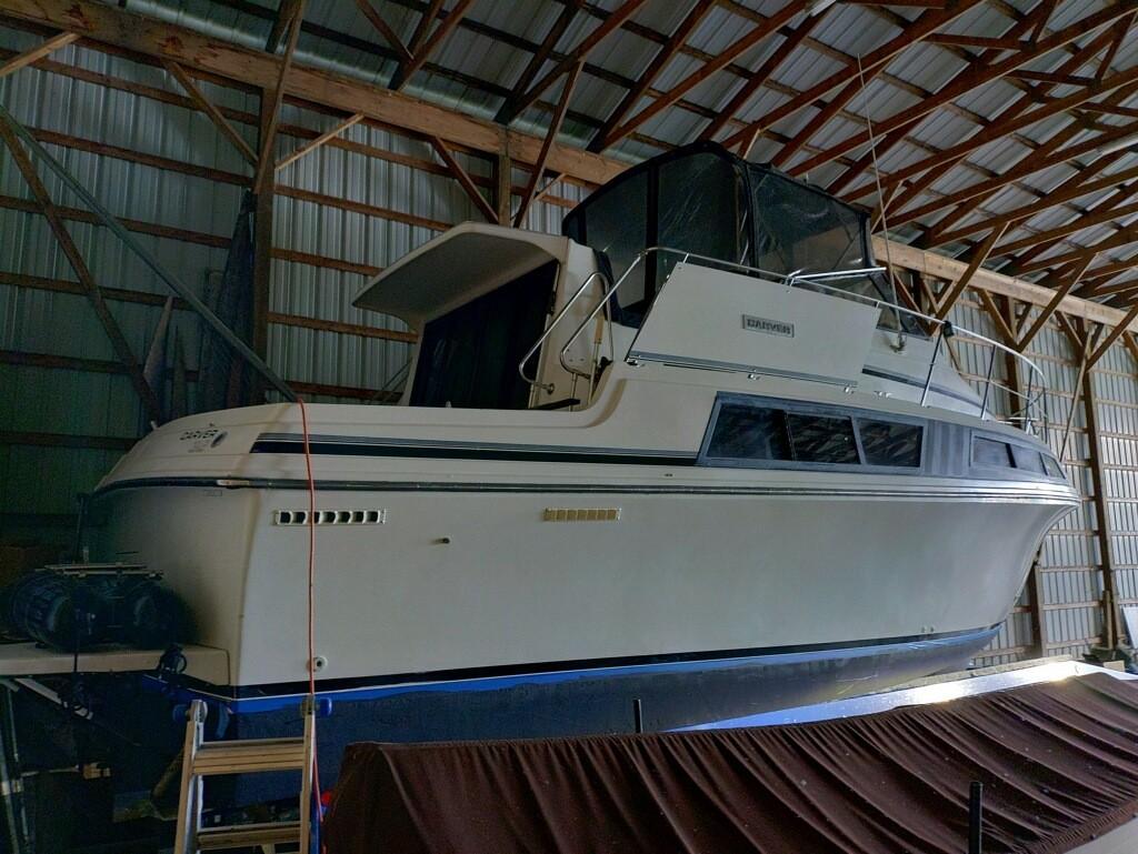 1988 Carver Mariner 32 yacht stored in a wooden boathouse.