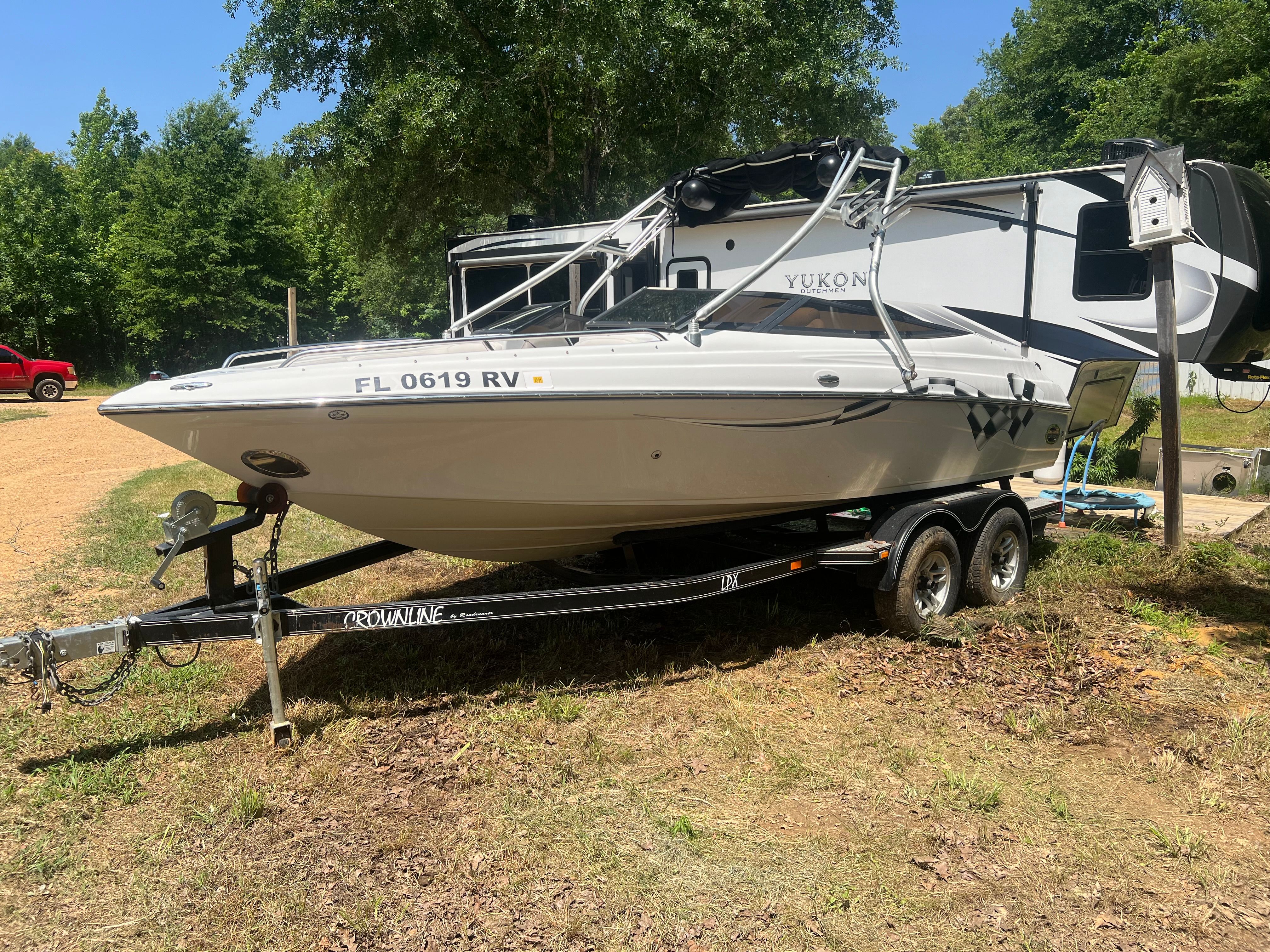 2001 Crownline 202 BR boat parked on trailer outdoors.