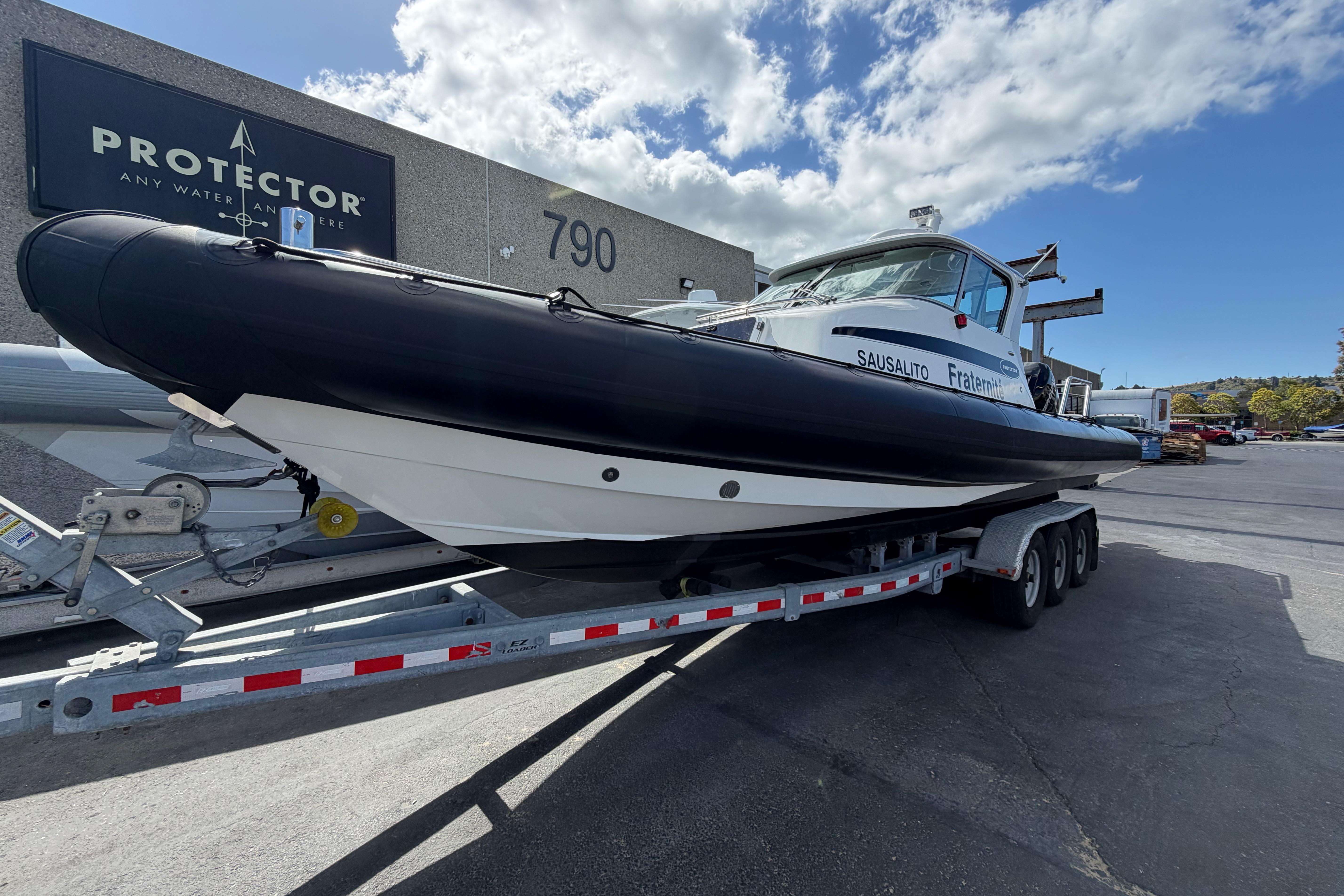 2016 Protector Targa 30 boat on trailer outside showroom.