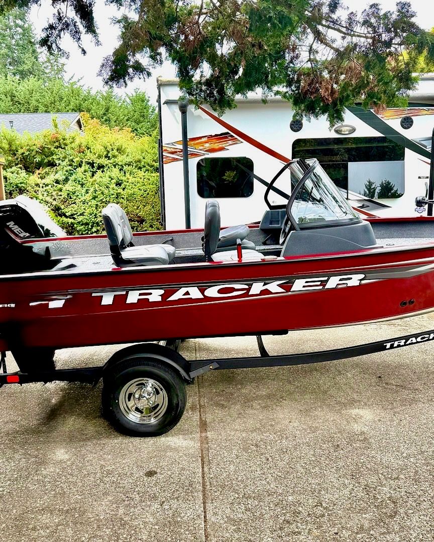 2025 Tracker Pro Guide V-16 WT boat on trailer outdoors.