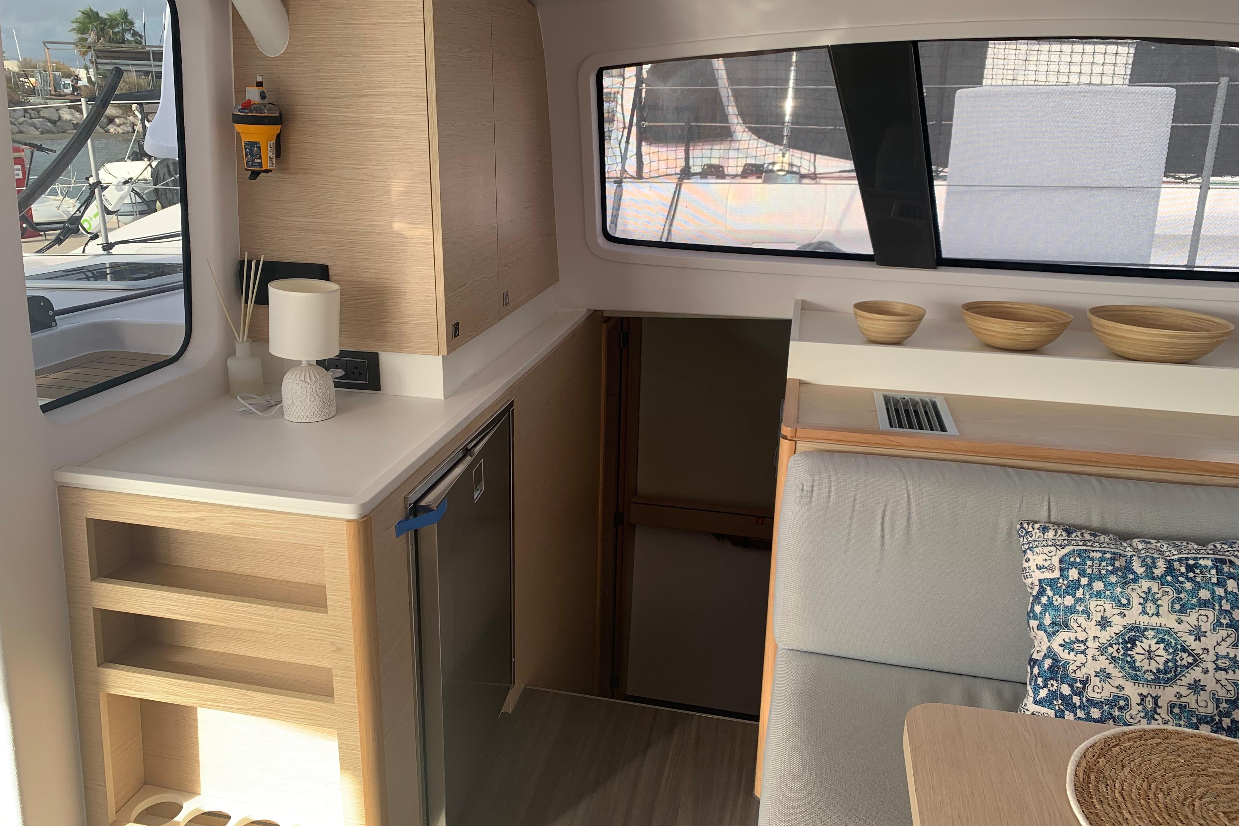 2024 Outremer 45 yacht interior with modern kitchen and cozy seating area.