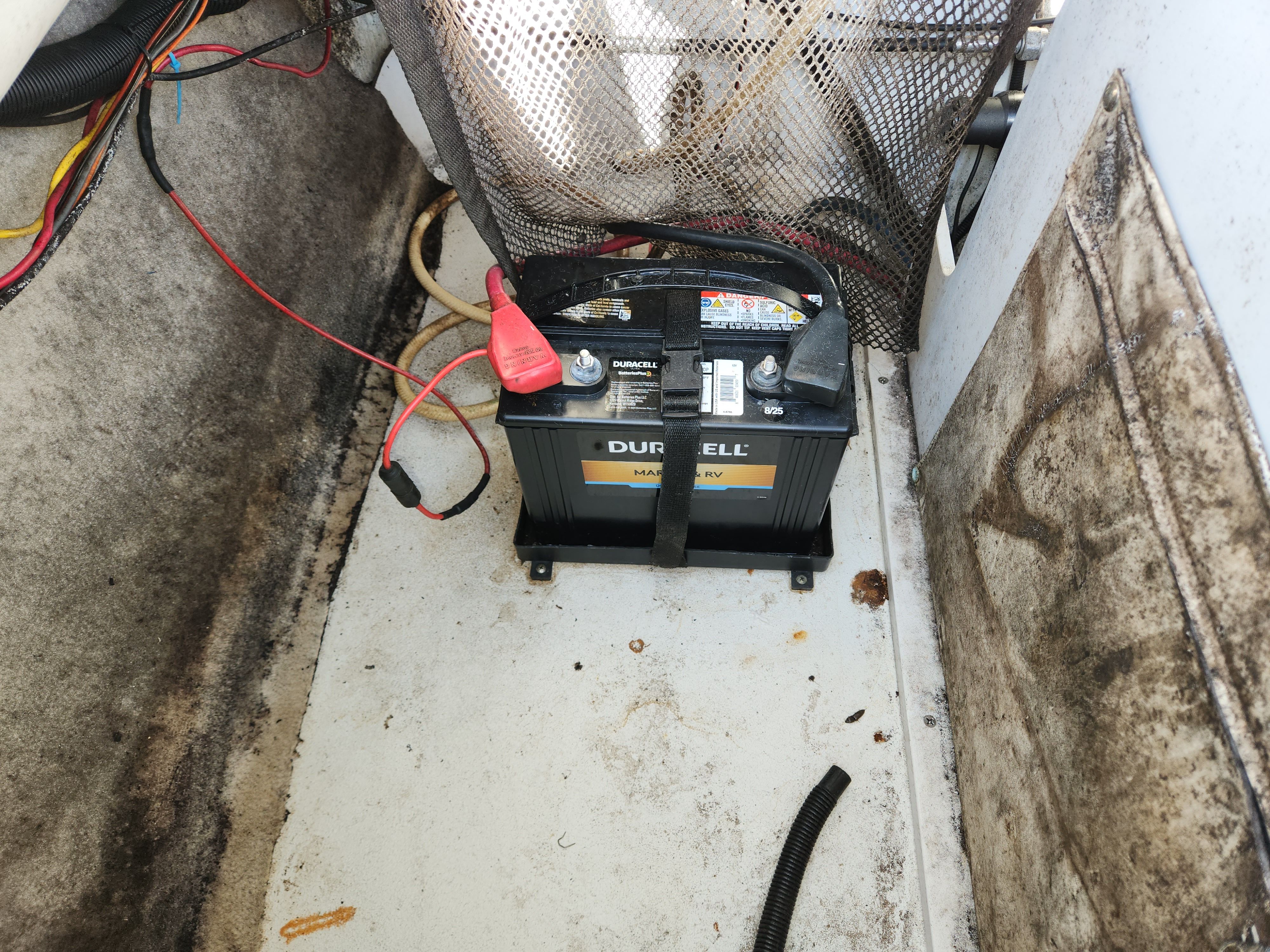 Boat battery in 2003 Crownline 225 BR, secured with straps.
