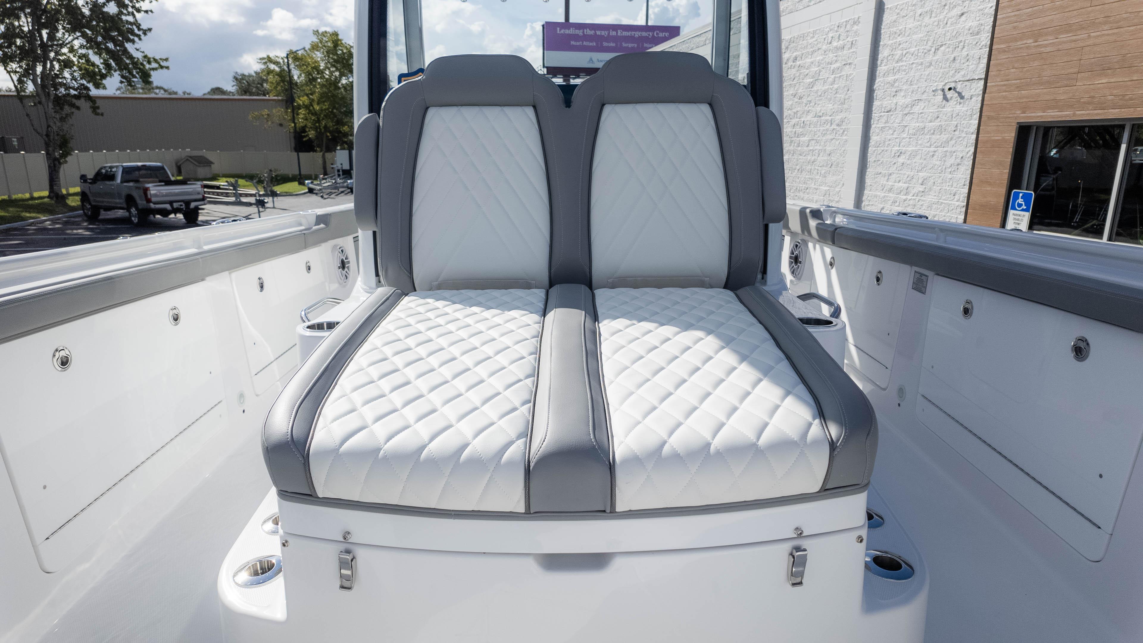 2025 Everglades 315 Center Console boat with luxurious white and gray seating.