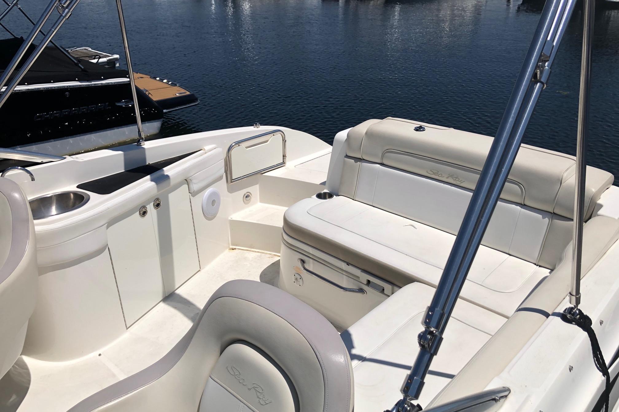2013 Sea Ray 260 Sundeck interior with seating and sink, docked on calm water.