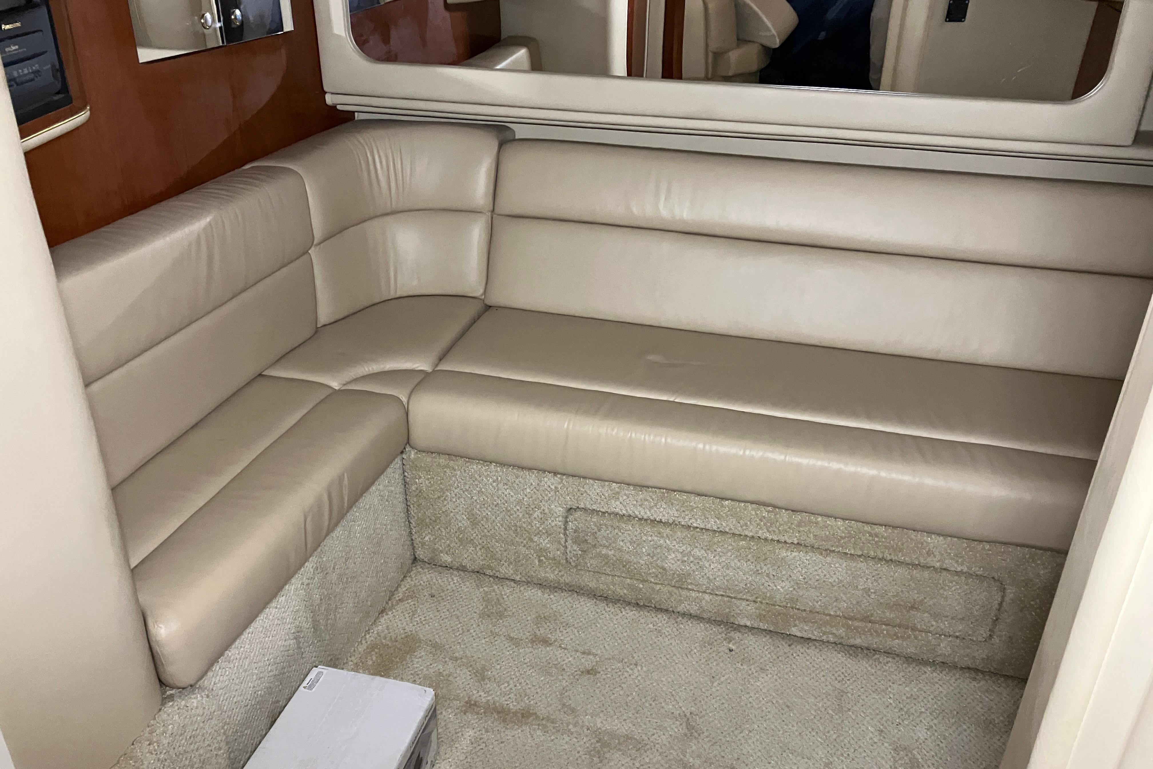 Interior of 2002 Sea Ray 410 Sundancer with beige leather seating and carpeted flooring.