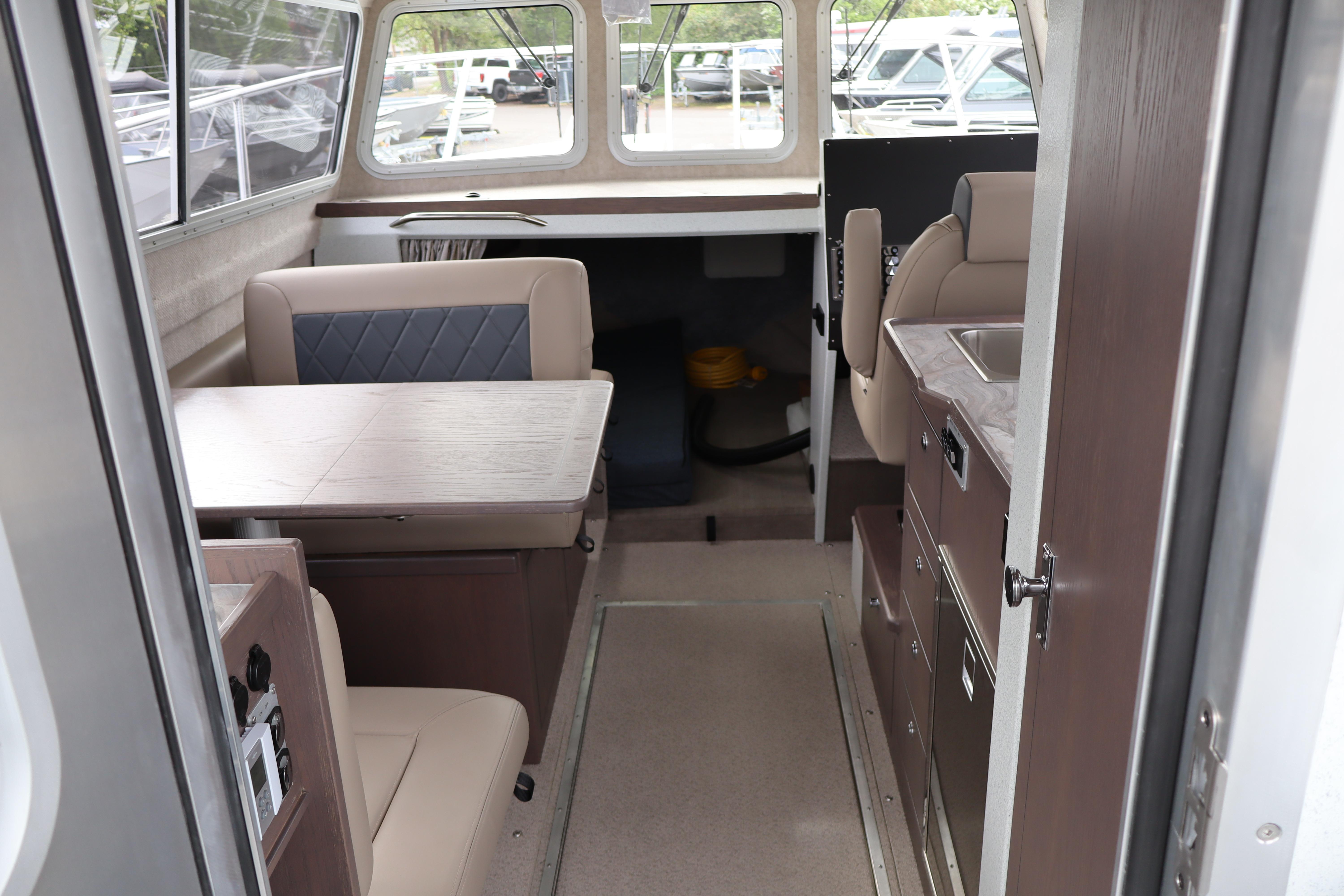 Interior of 2026 KingFisher 3025 XRS boat with seating and kitchenette.