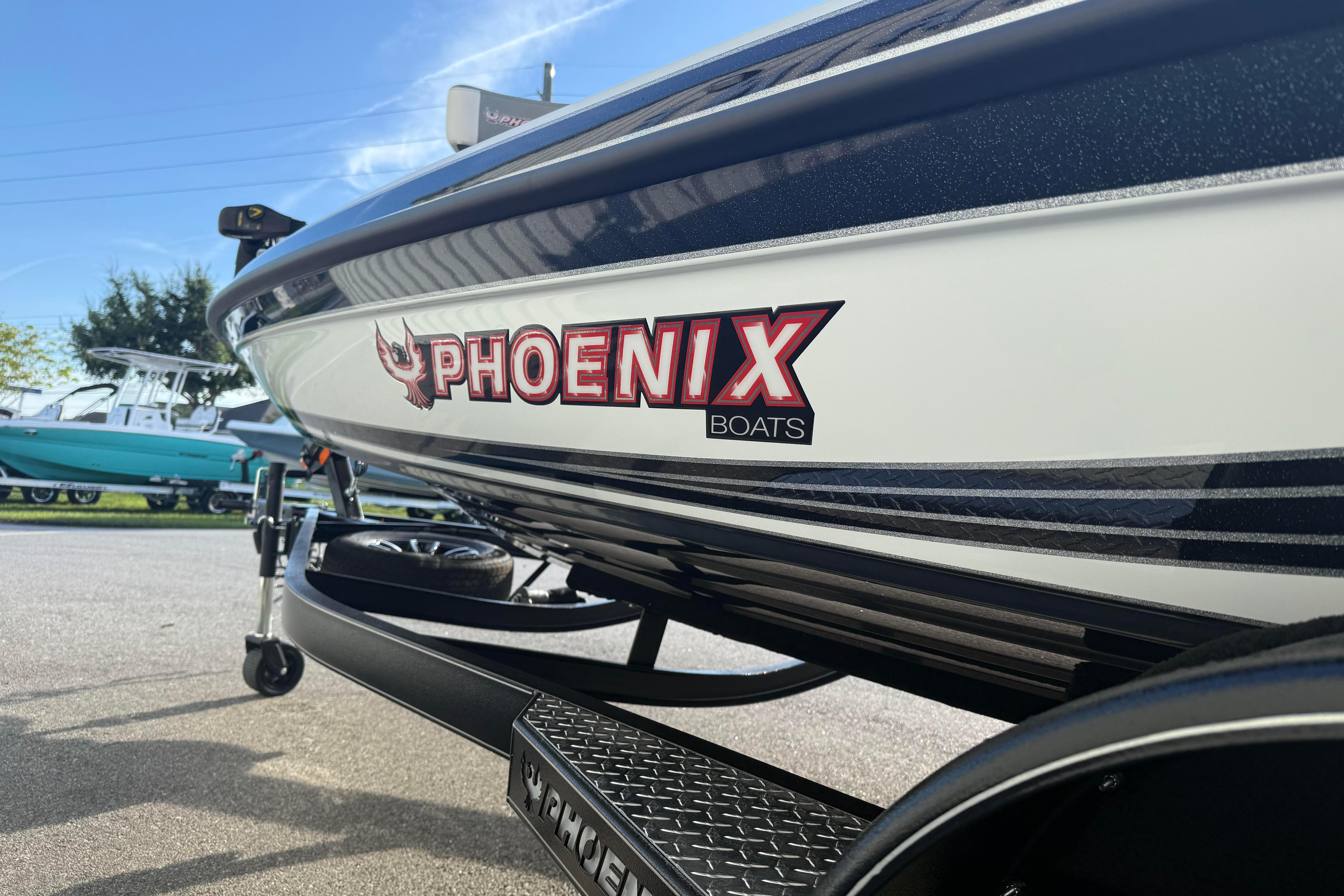 2027 Phoenix 721 ZXL boat on trailer, showcasing sleek design and branding.