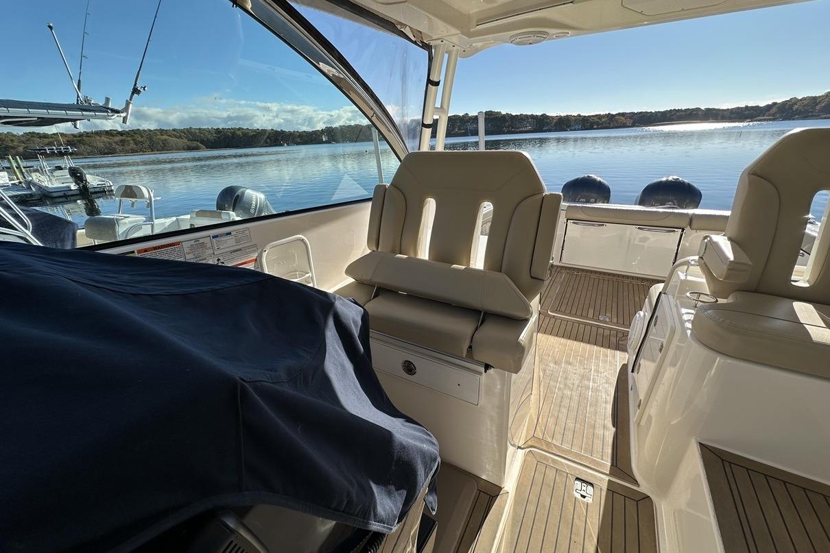2016 Pursuit DC 325 Dual Console boat interior with lake view and seating.