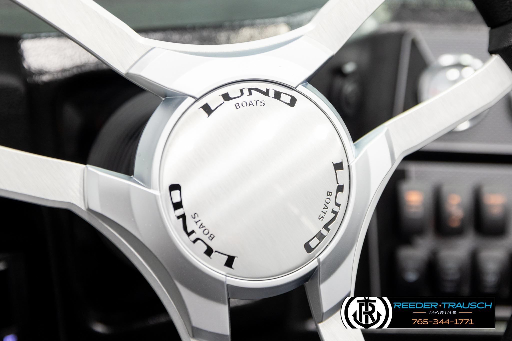 Steering wheel of 2026 Lund 1975 Tyee boat, featuring sleek design and branding.