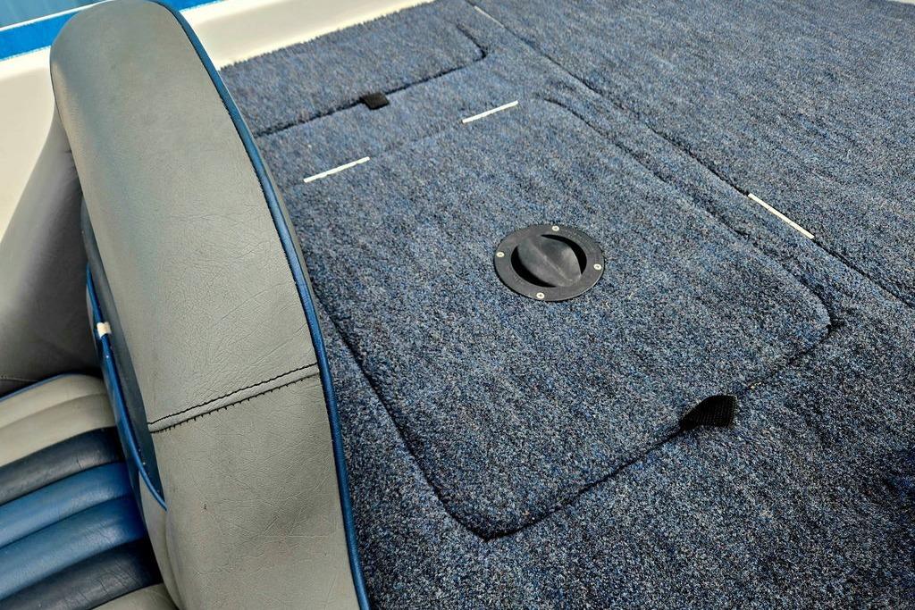 1996 Champion 181 SX boat interior with blue carpet and seating.