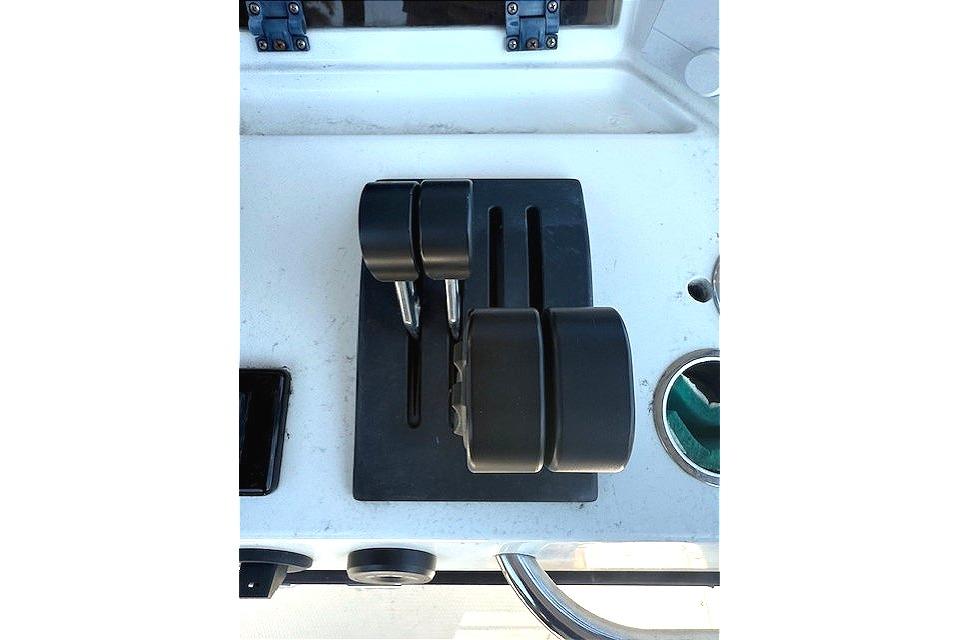 Throttle controls on a 1996 Powerplay Powerboats 33 Sportfish dashboard.