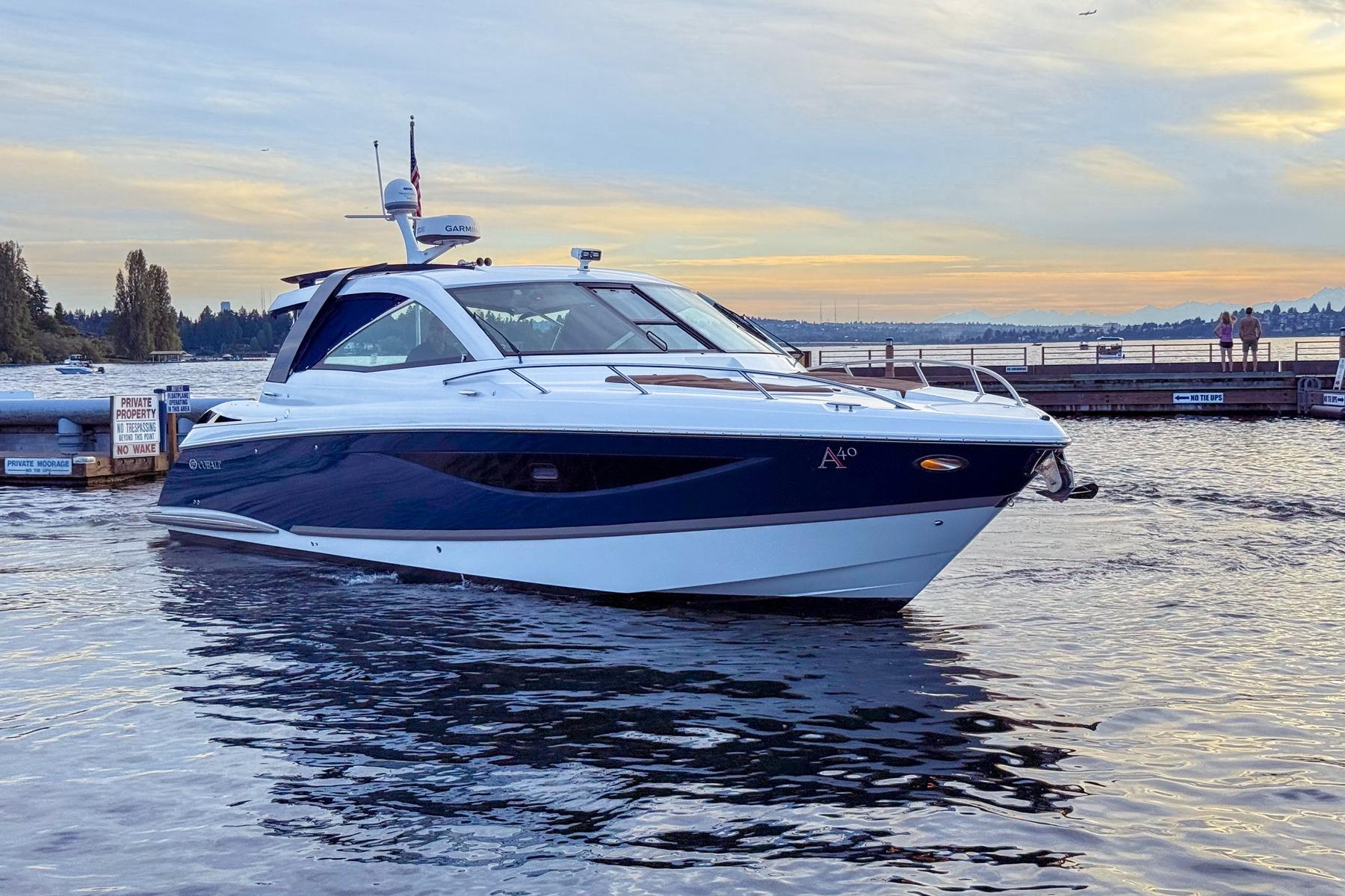2017 Cobalt A40 Coupe boat on water at sunset near dock.
