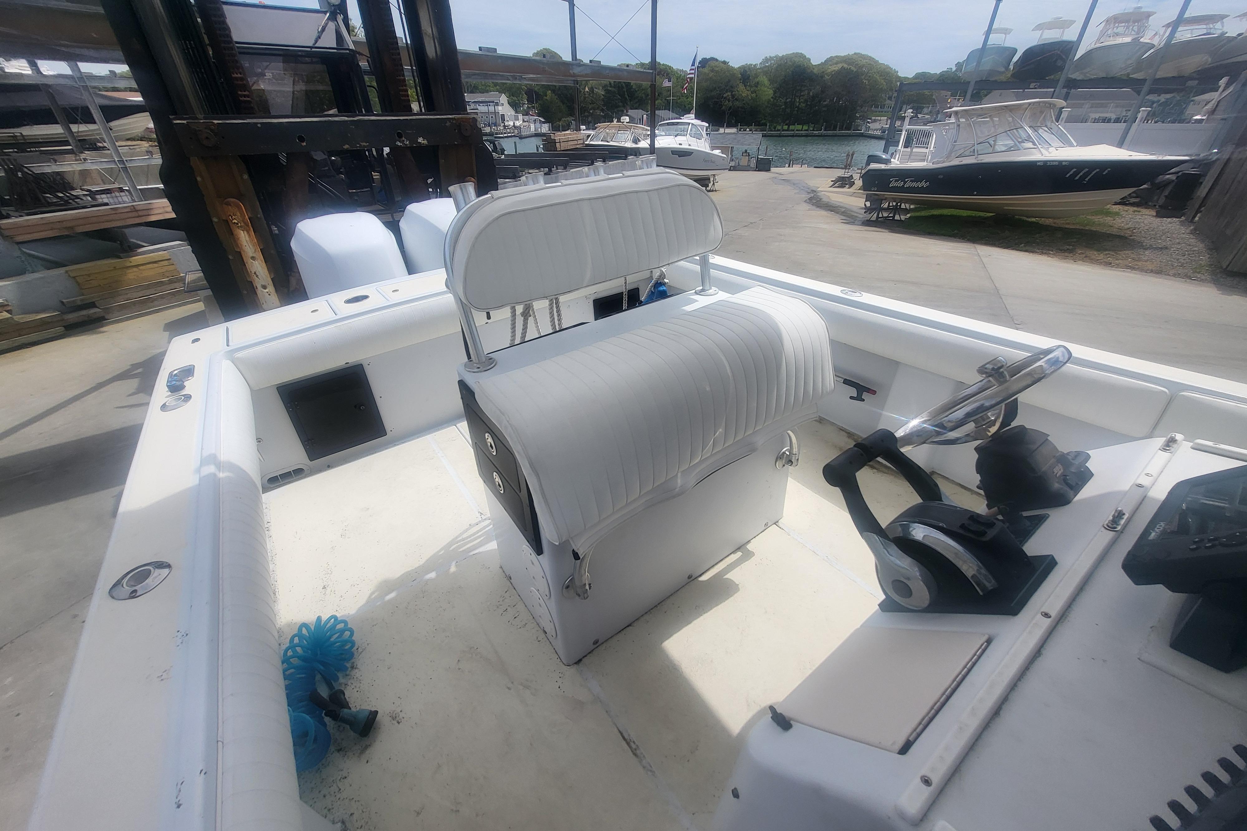 2001 Regulator 26 Center Console boat interior with steering wheel and seating.