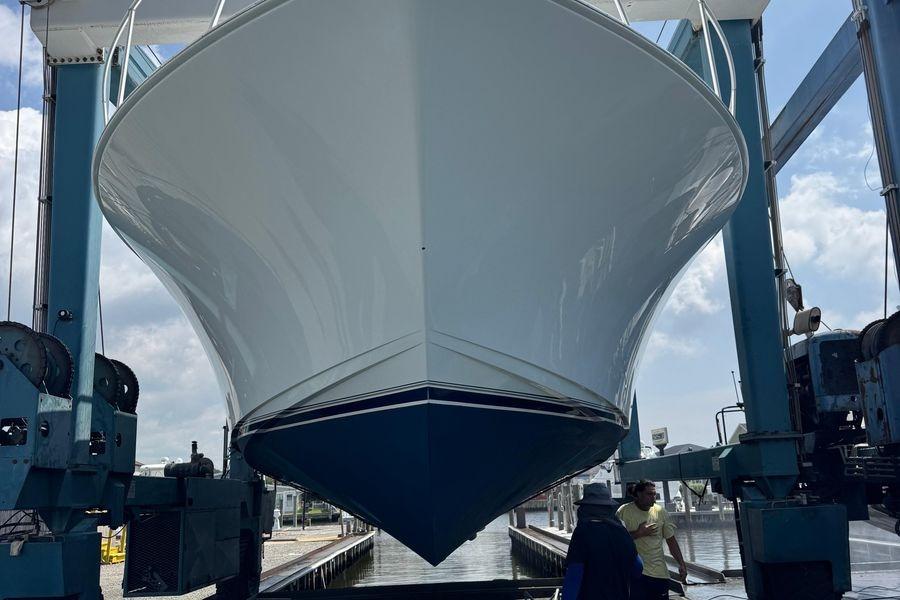 2002 Viking 61 Enclosed Bridge yacht in dry dock, viewed from the front.