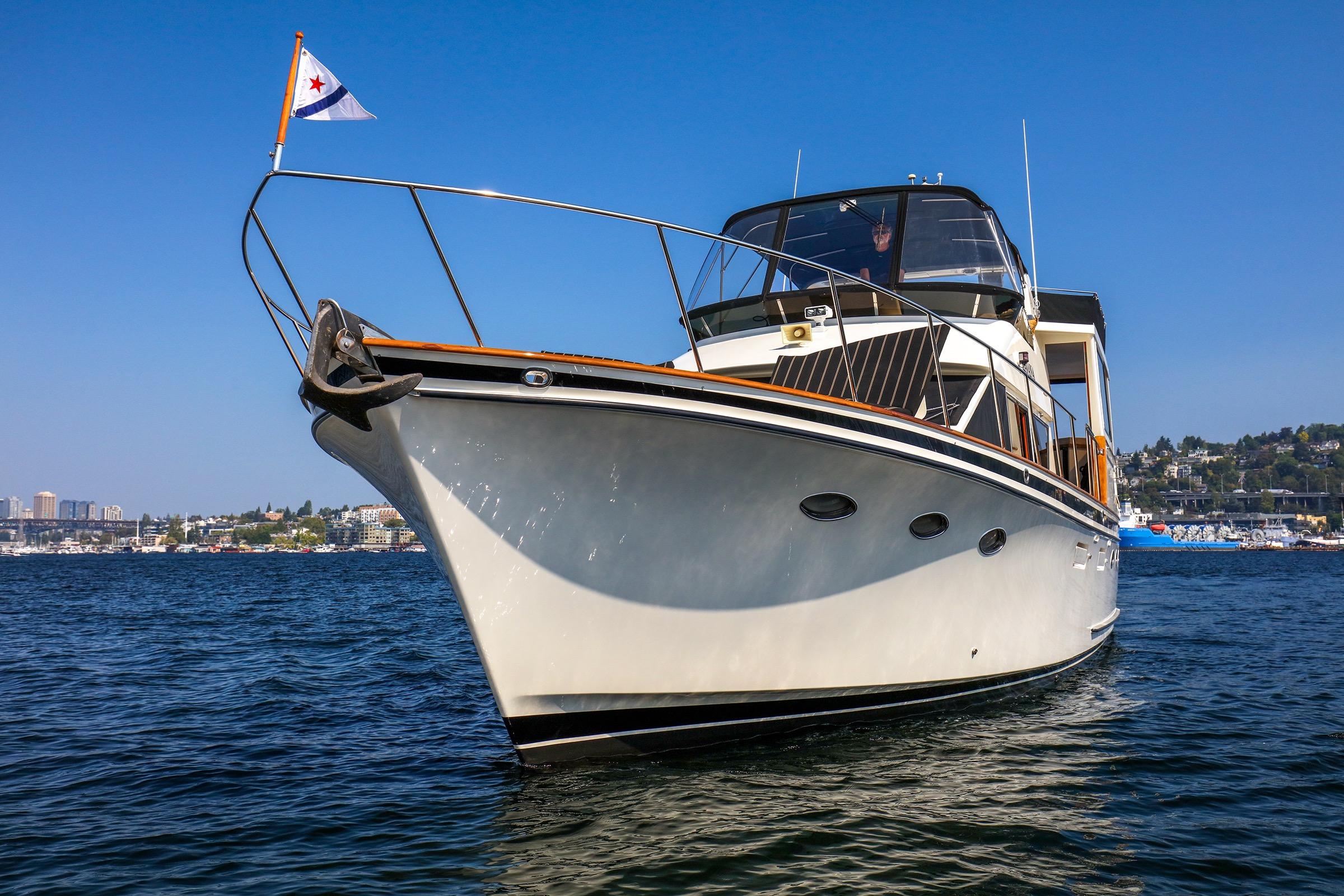 1987 Ocean Alexander 480 Sport Sedan yacht on open water, clear blue sky background.