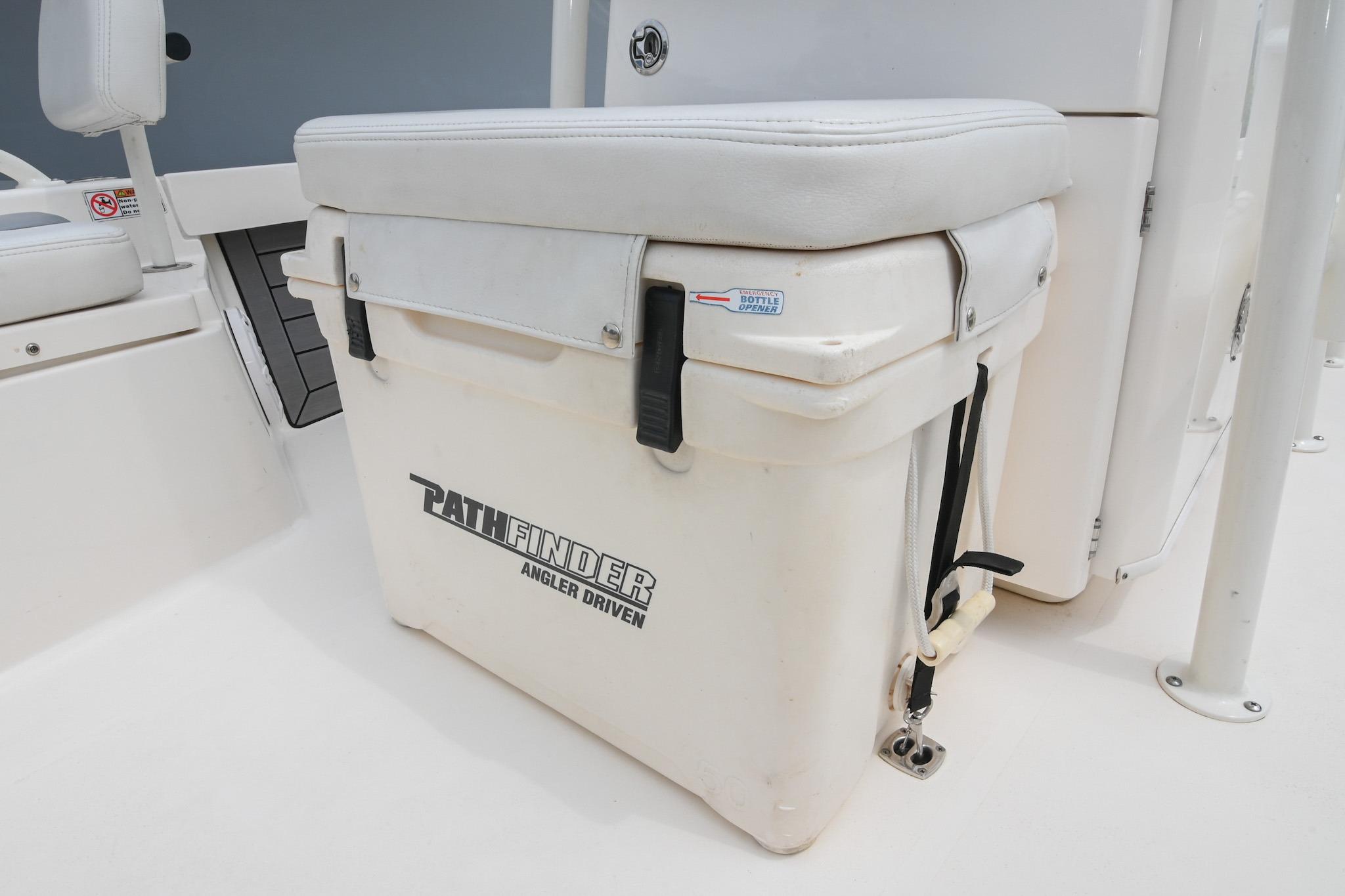 2021 Pathfinder 2200 TRS boat cooler seat with white cushion and secure straps.