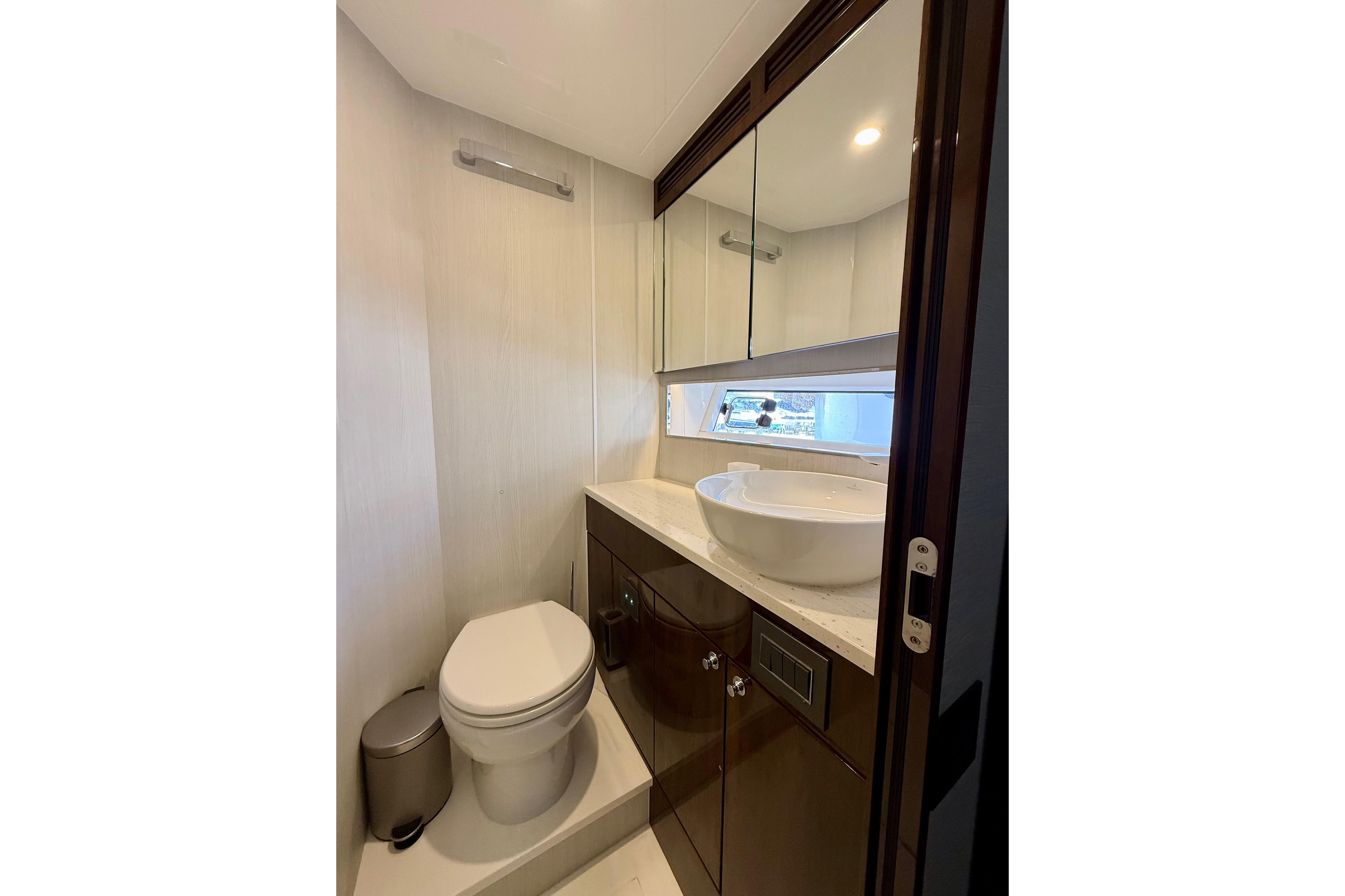 Luxury bathroom in 2022 Fairline Squadron 68 yacht, featuring modern fixtures and elegant design.
