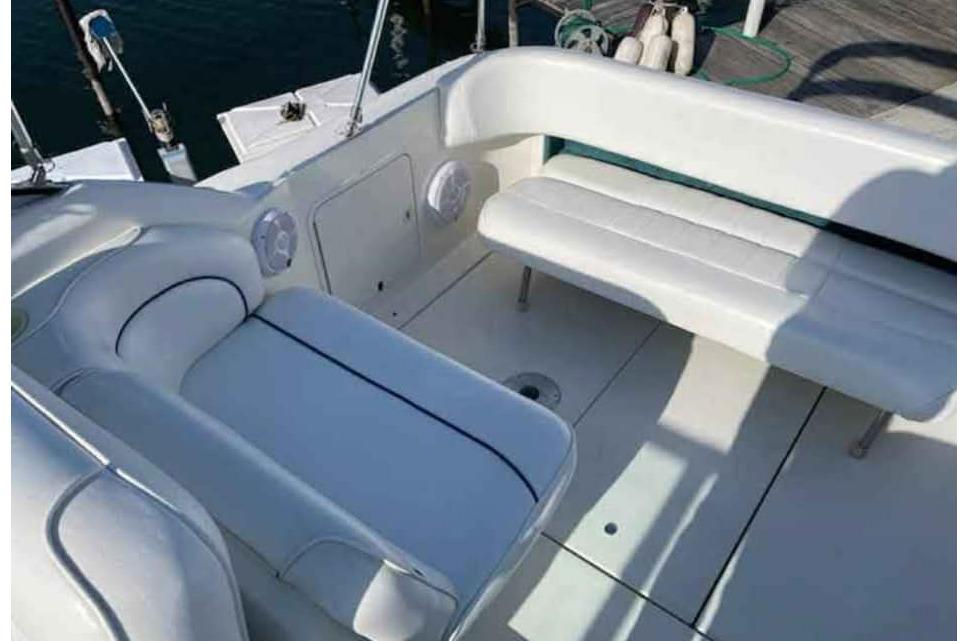 1996 Sea Ray 270 Sundancer boat interior with white seating and deck.