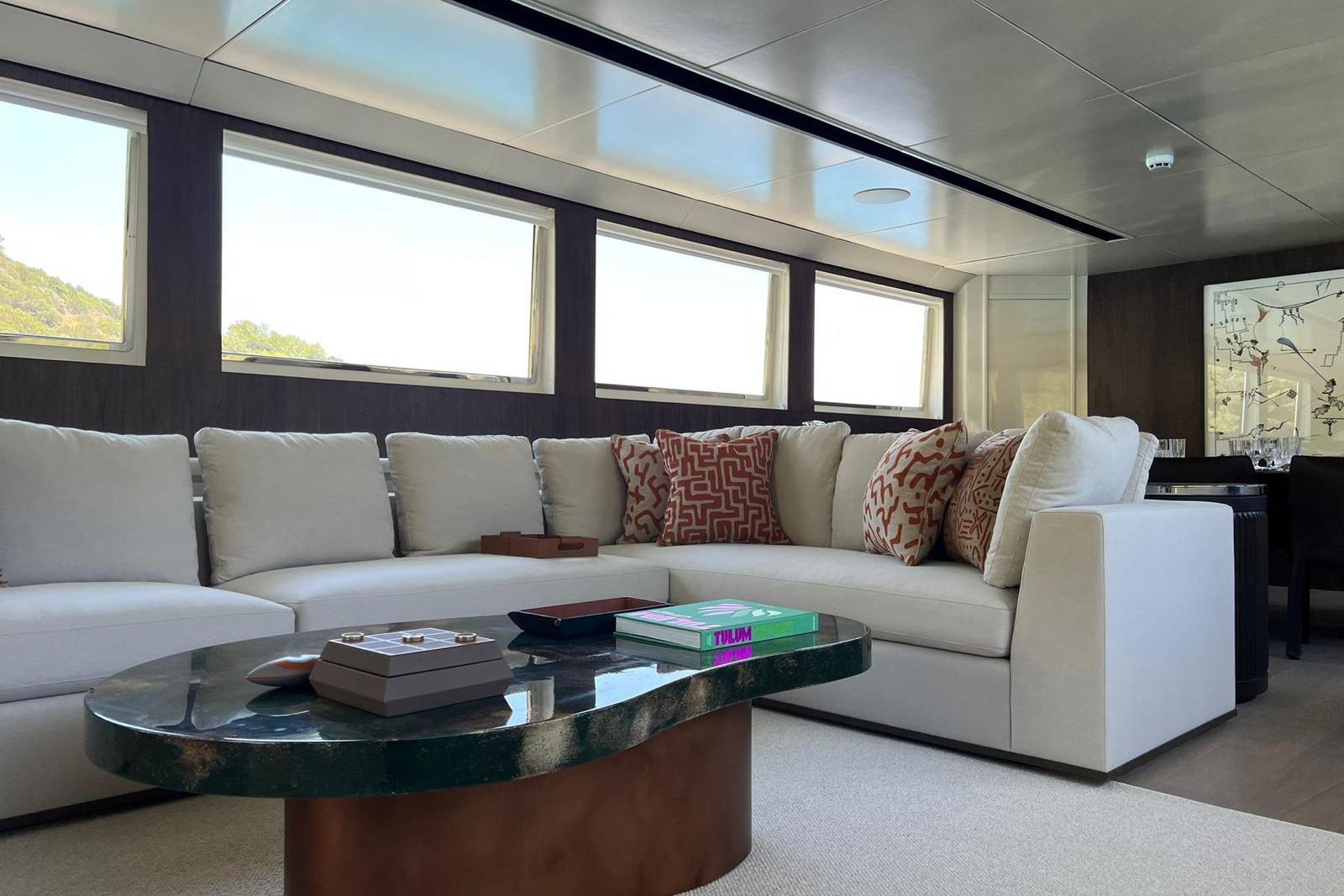 Luxurious interior of 1991 Crestitalia 33m yacht with elegant sofa and modern decor.