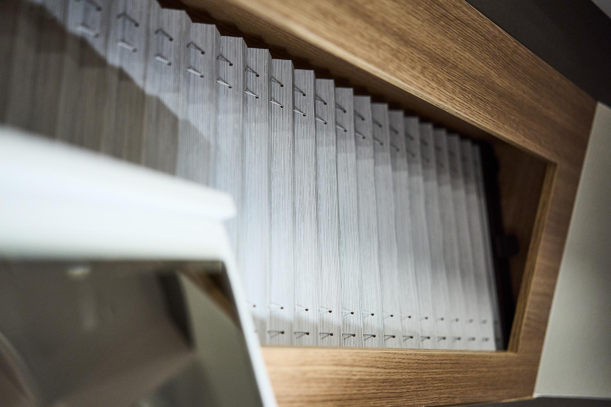 Pleated window blind in a Northman 1300, 2025 model, with wooden frame detail.