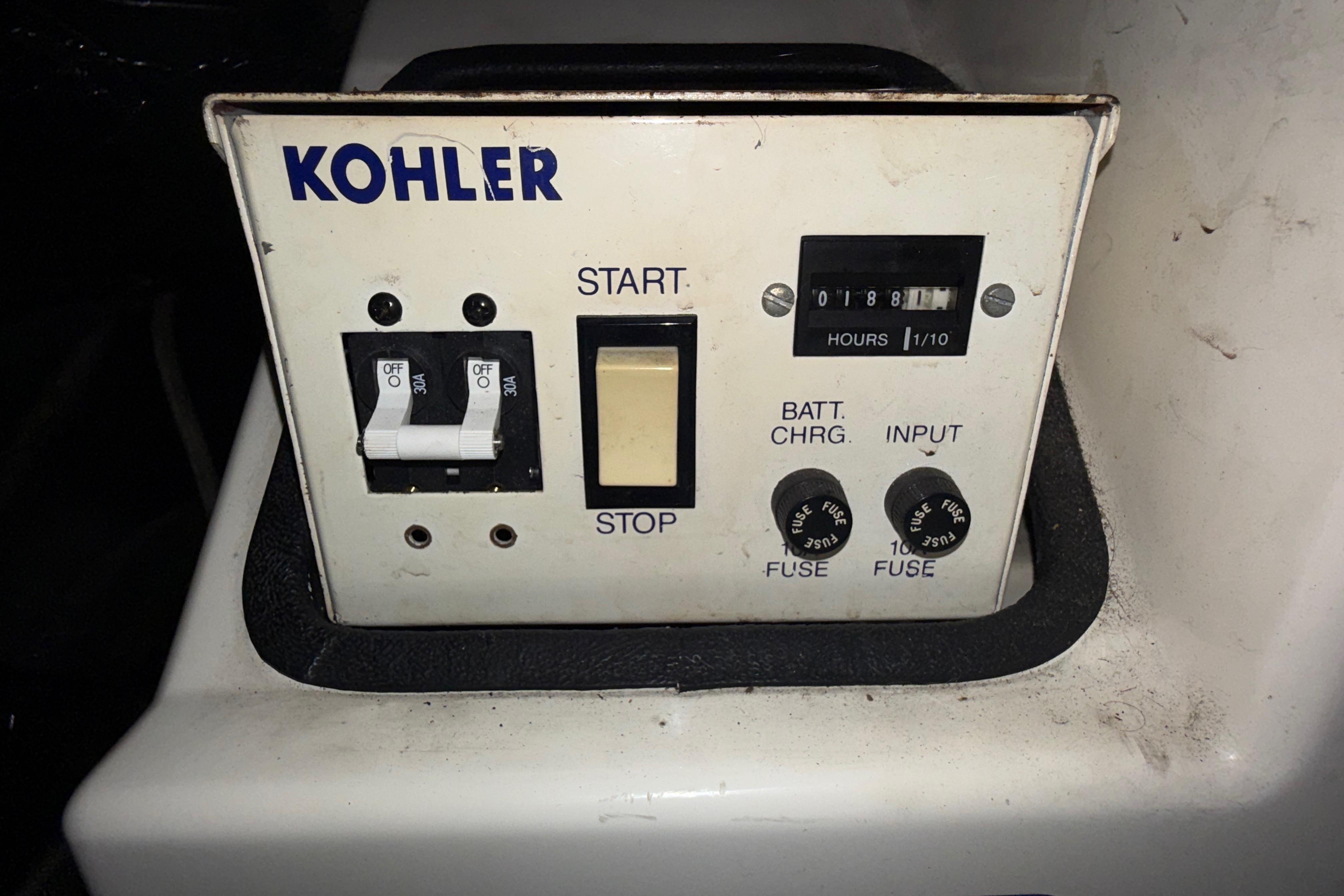 Kohler control panel on 1992 Carver 33 Aft Cabin Motor Yacht, featuring switches and hour meter.