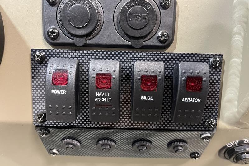 Control panel of 2025 SeaArk Shadow 18T boat with power, navigation, bilge, and aerator switches.