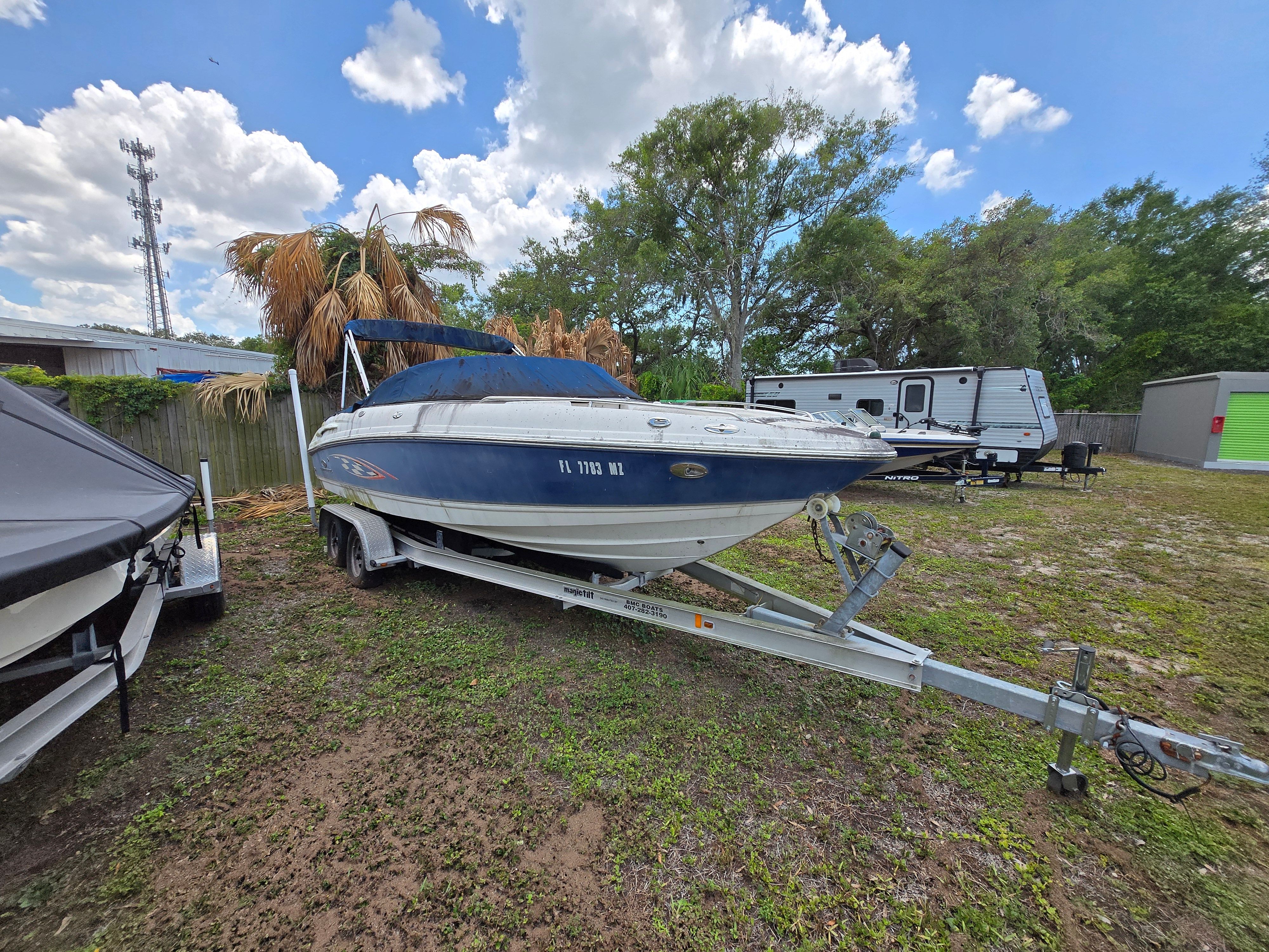 A 2006 Chaparral 220 SSi boat on a trailer in an outdoor setting.