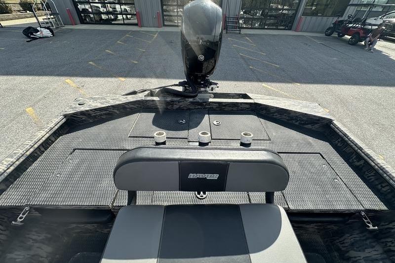 2023 Havoc 1756 MRST boat interior with motor and seating, parked outdoors.