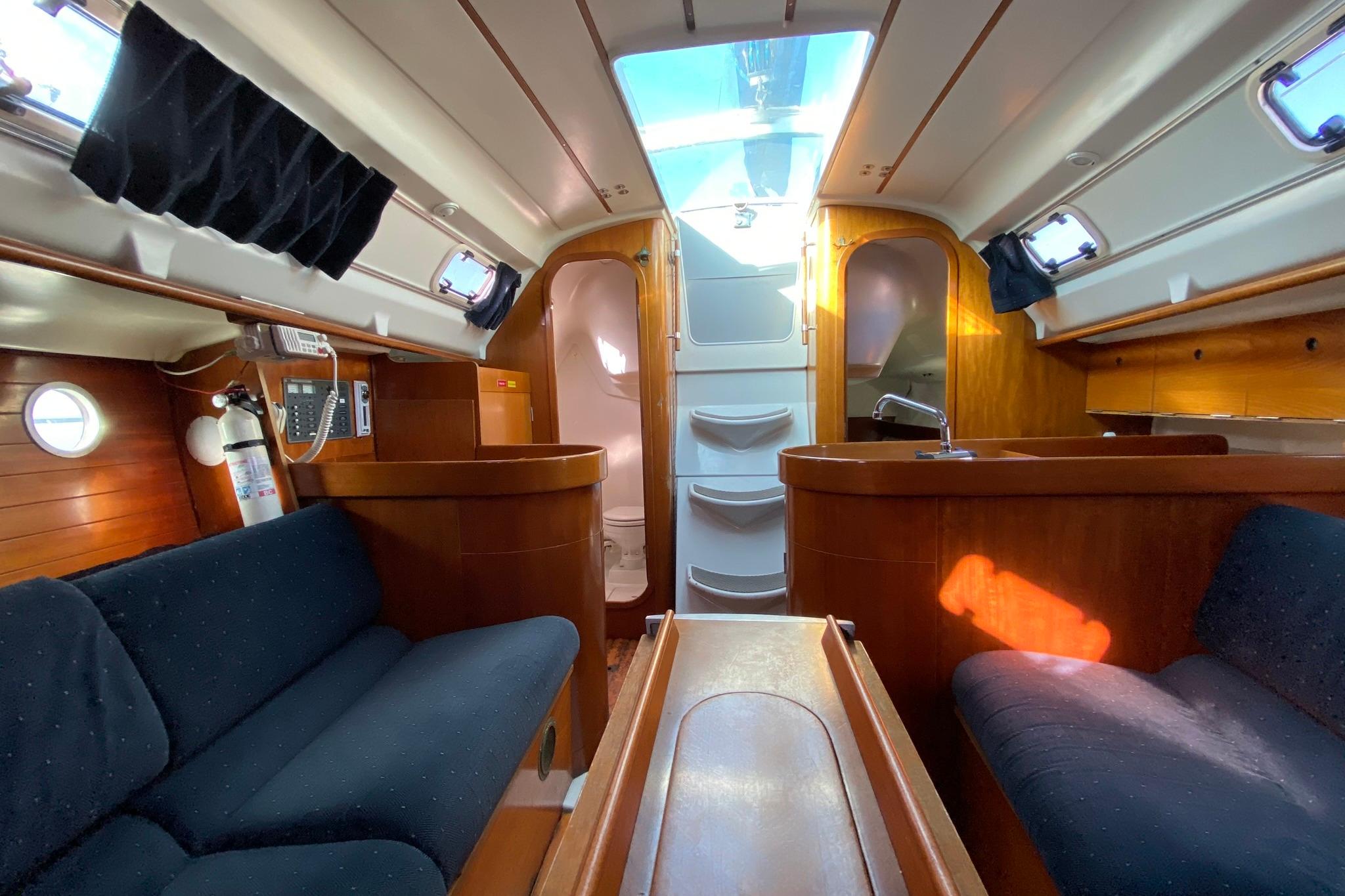 Interior of 1993 Beneteau First 310 sailboat with wood finish and seating area.