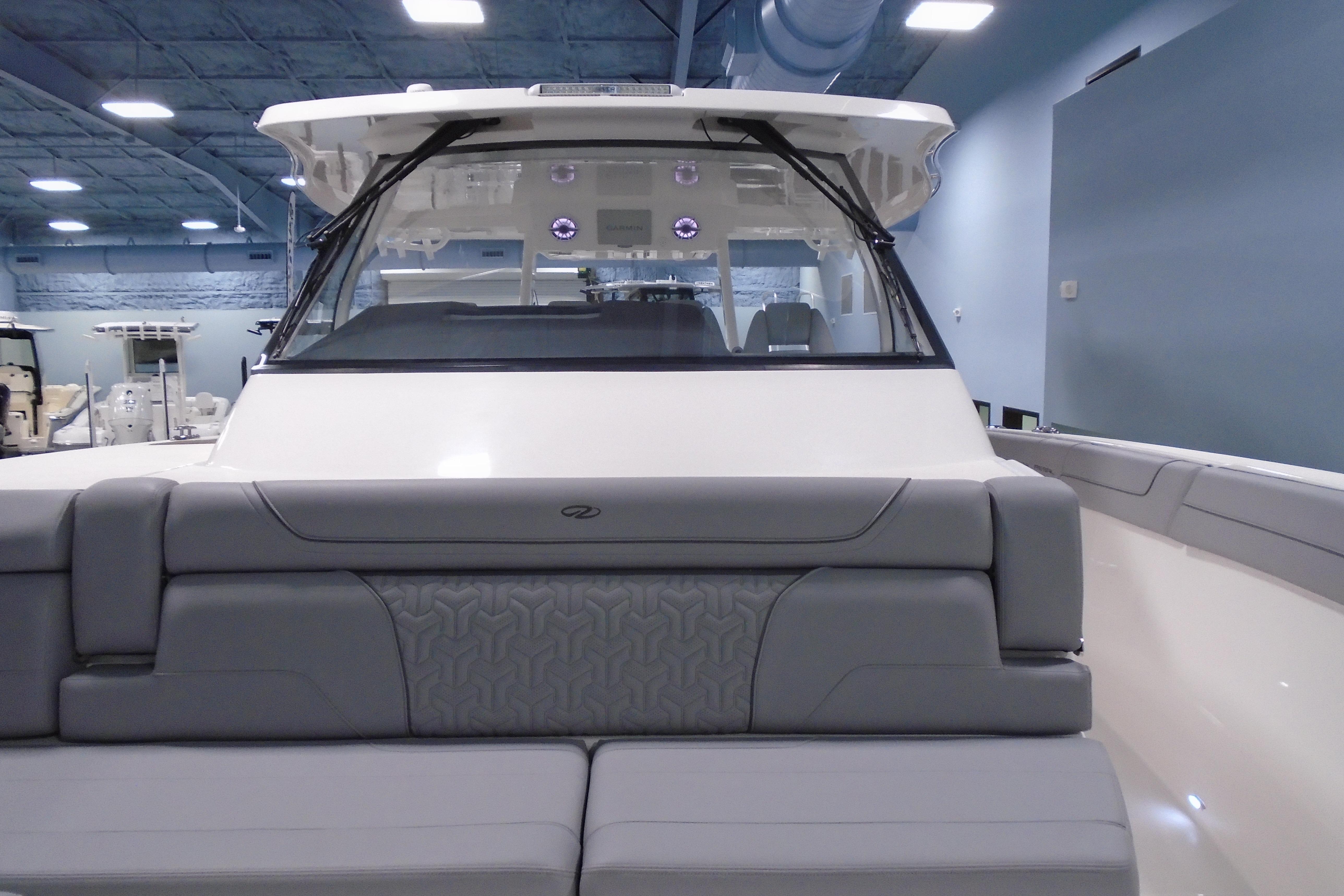 2026 Regal 38 SAV boat interior with gray seating in a showroom.