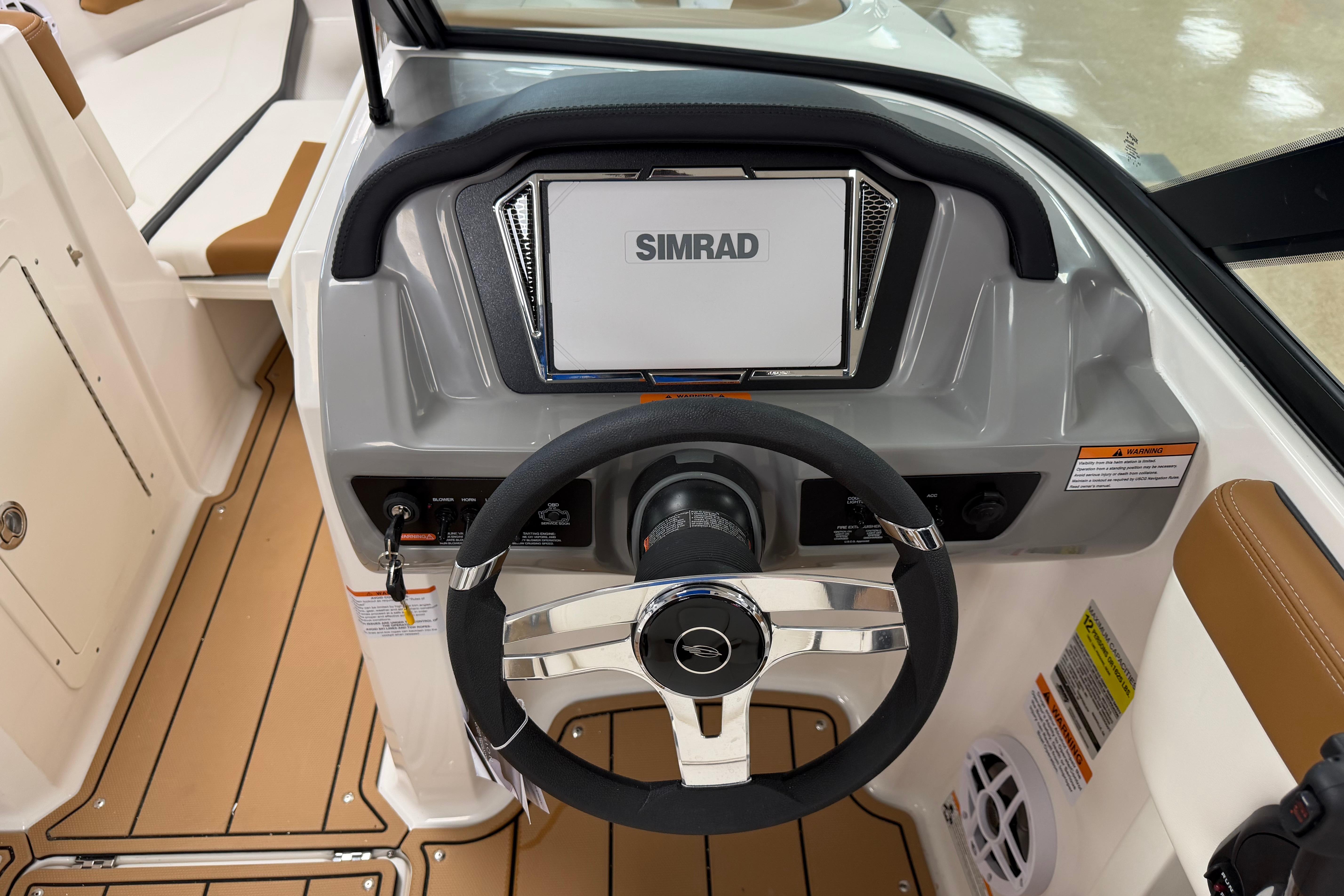2026 Chaparral 21 SSi Ski & Fish boat dashboard with Simrad display and steering wheel.