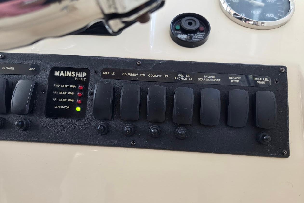 Control panel of 2009 Mainship Pilot 31 boat with labeled switches and indicators.