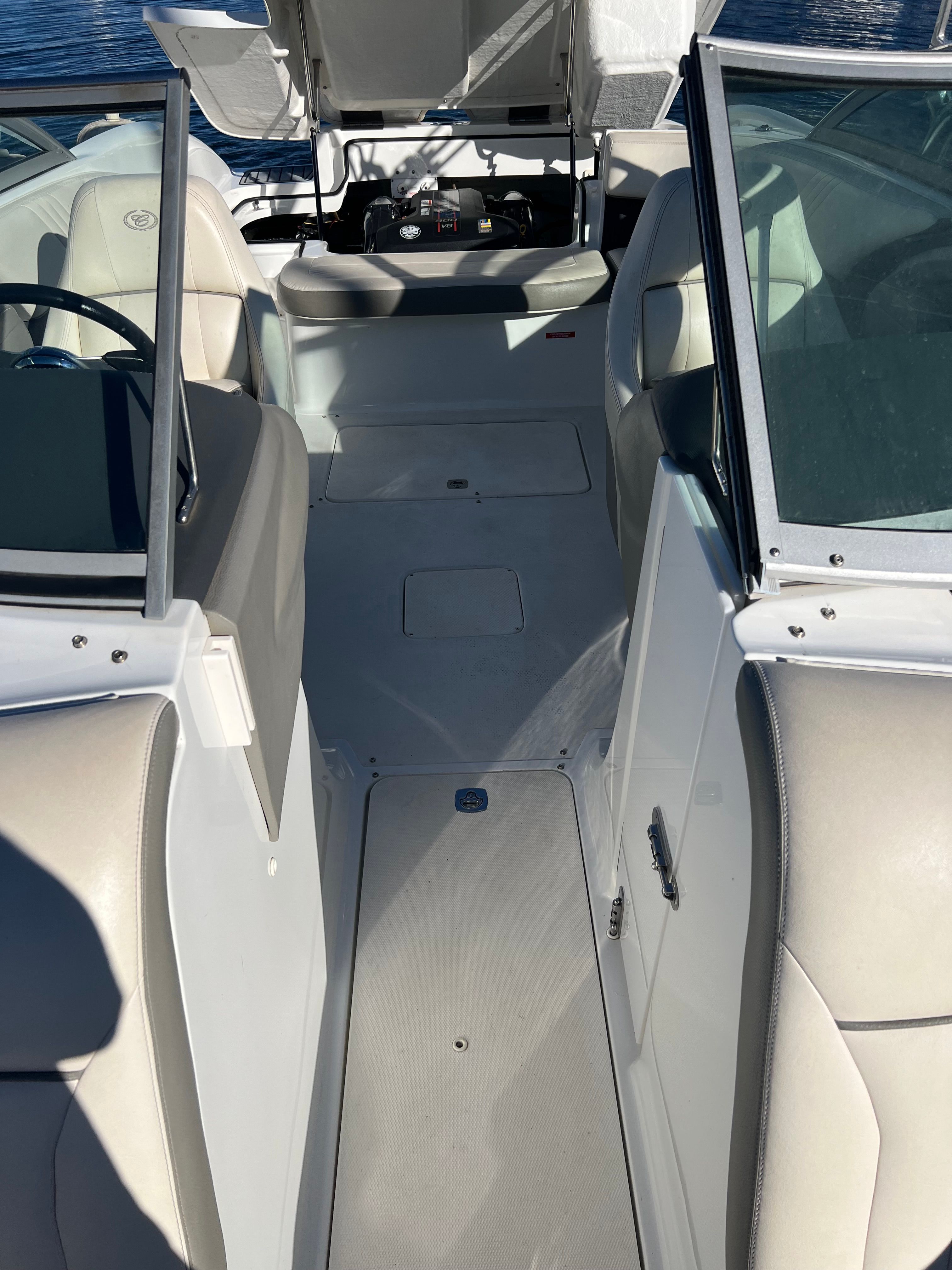 Interior of a 2012 Cobalt 232 boat with beige seats.