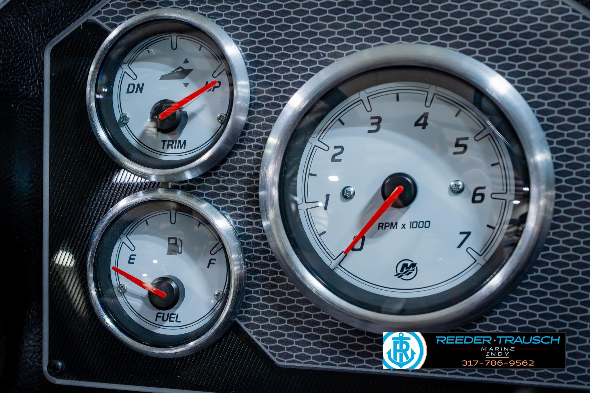 Dashboard gauges of 2026 Lund 1875 Impact XS boat, featuring trim, fuel, and RPM indicators.