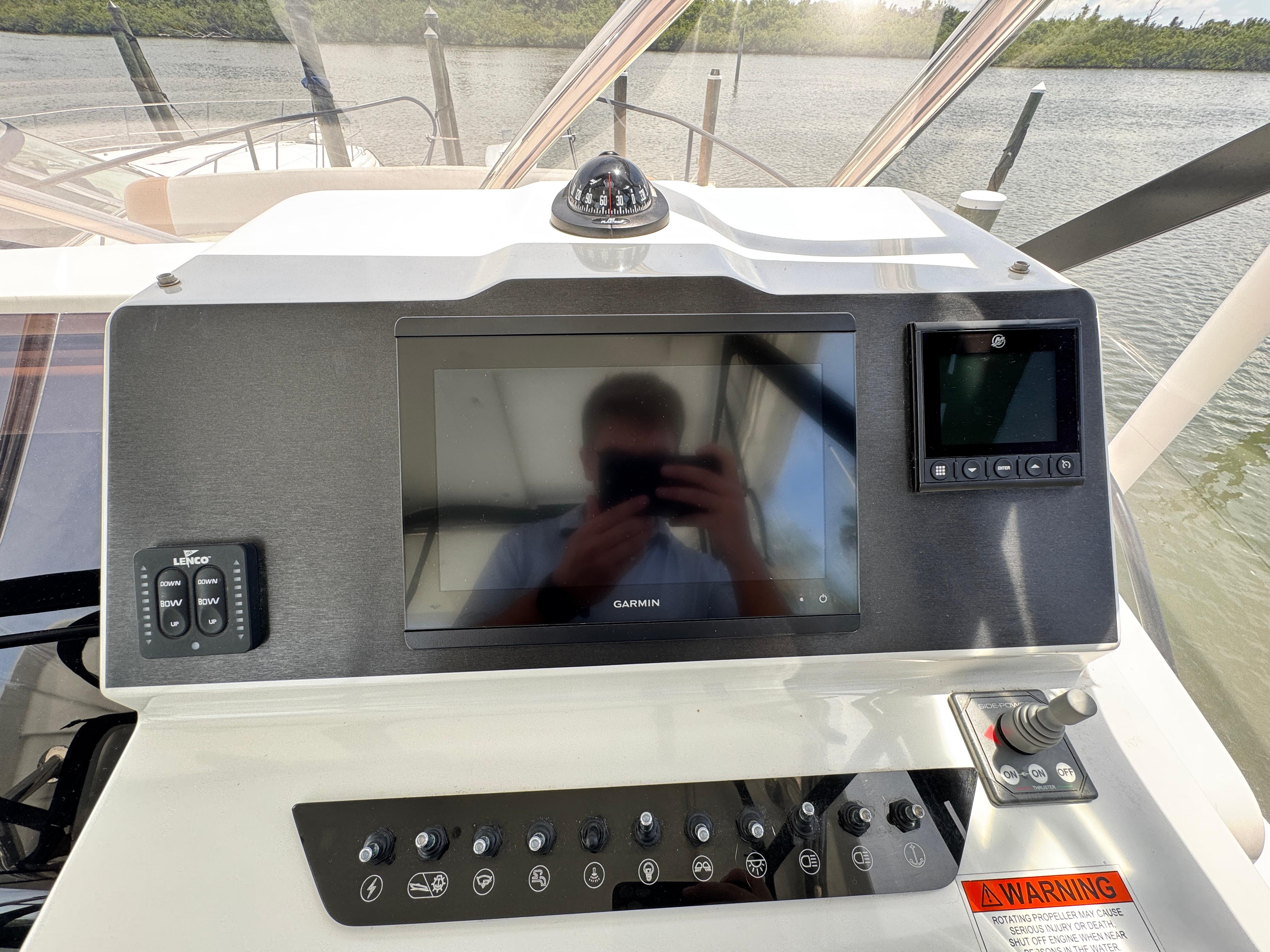 Control panel of 2022 Beneteau Flyer 9 SUNdeck with Garmin display and various controls.