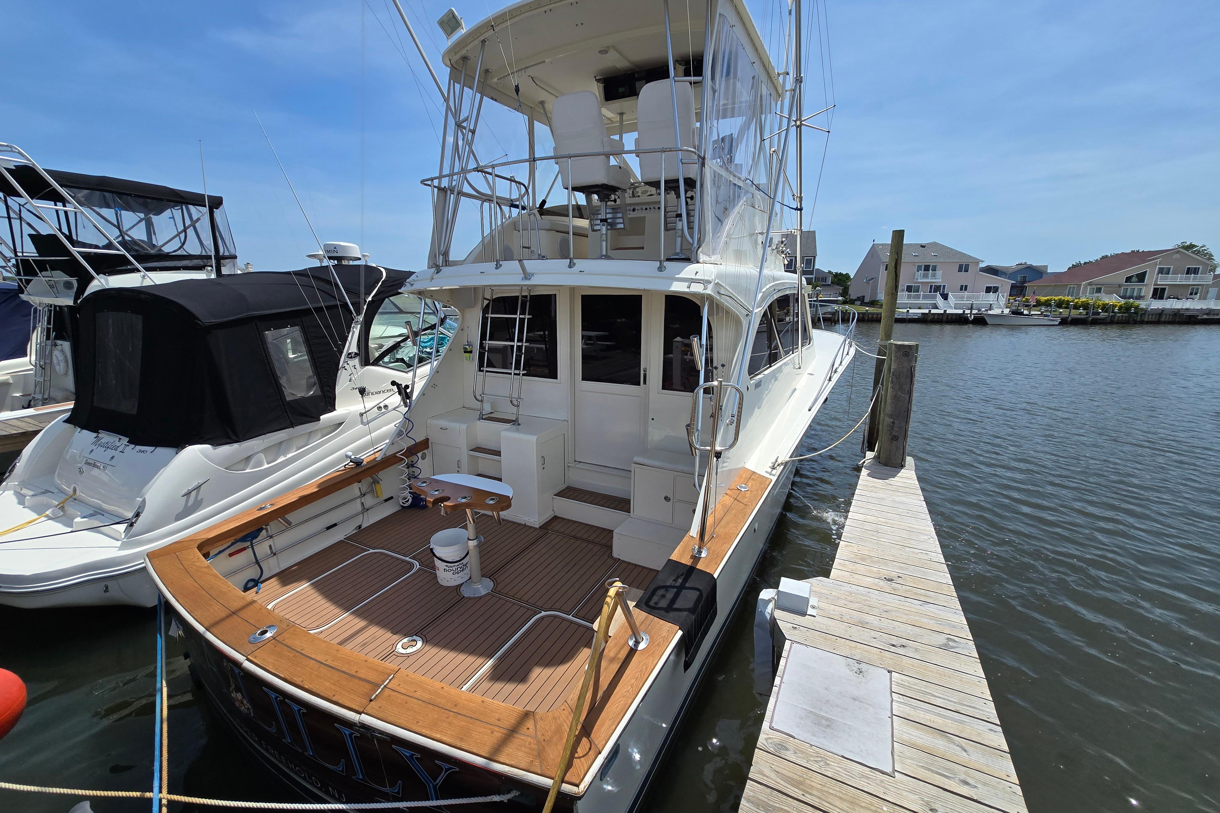 1988 Post 46 Convertible yacht docked at marina, featuring spacious deck and flybridge.