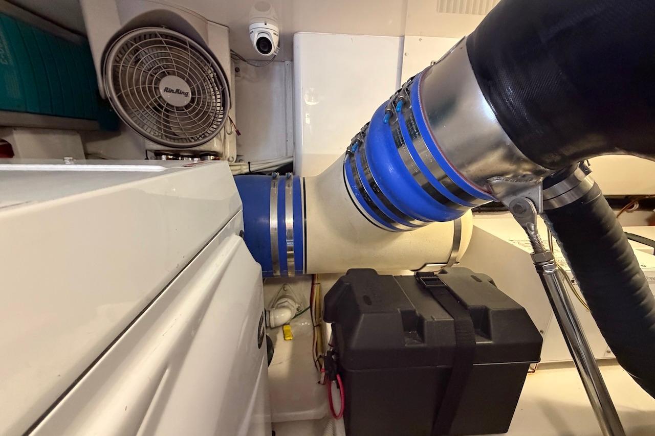 Engine room of 2012 Viking 50 Convertible yacht with ventilation and piping system.